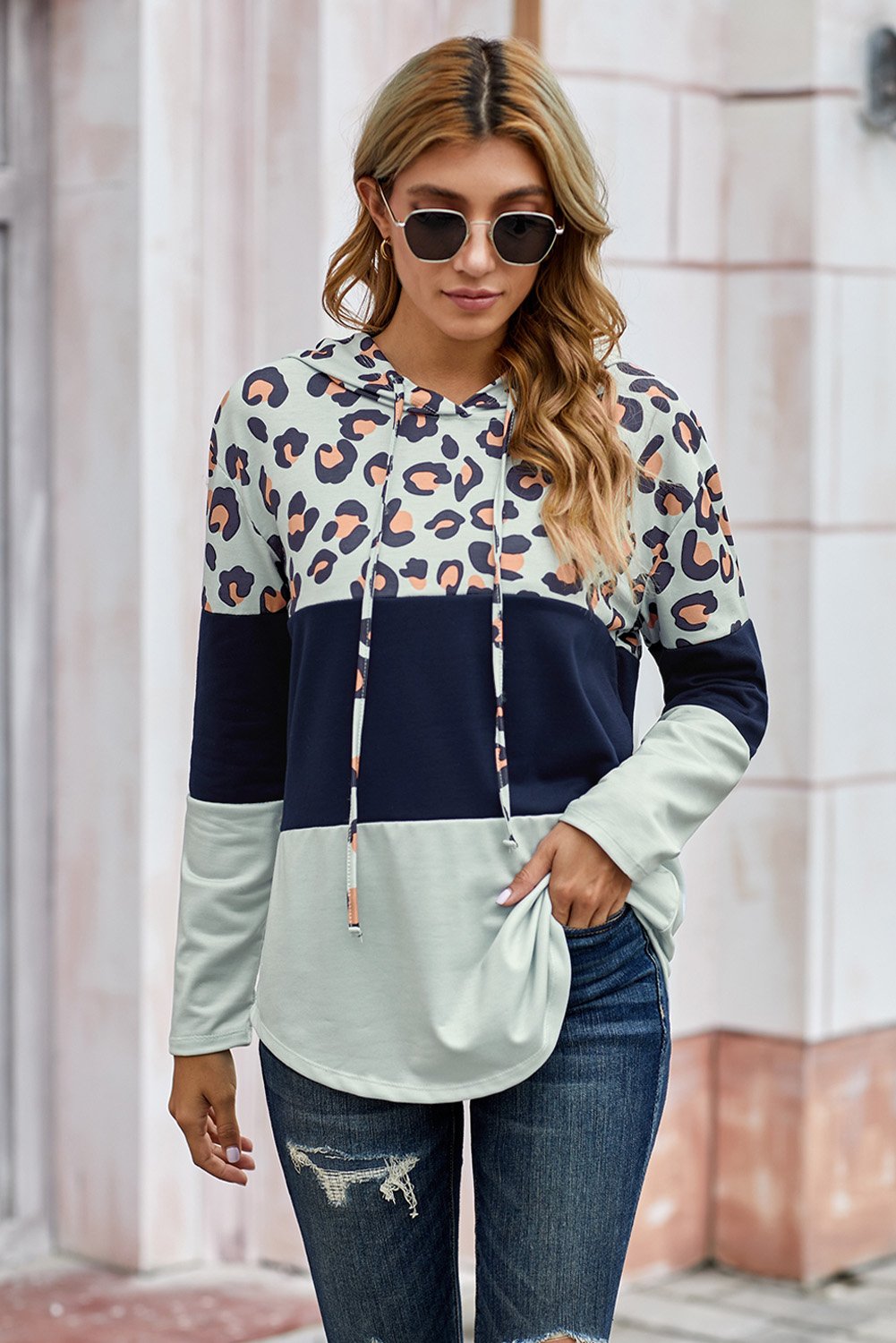 Leopard Color Block Drawstring Hoodie featuring a stylish design with triple color stitching and a chic leopard print.