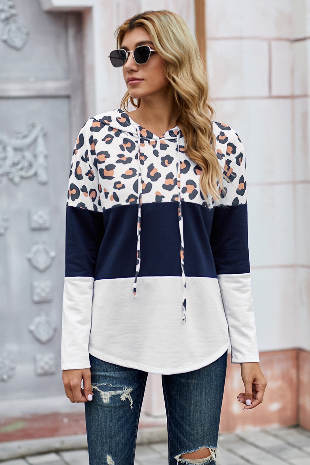 Leopard Color Block Drawstring Hoodie featuring a stylish design with triple color stitching and a chic leopard print.