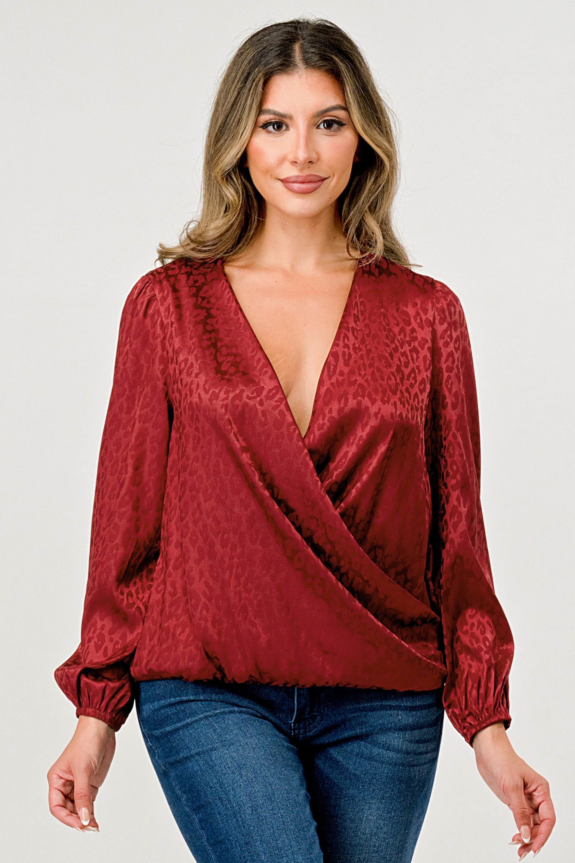 Leopard Print V-Neck Wrap Blouse with long sleeves and elastic waist, showcasing a chic satin finish and elegant jacquard pattern.