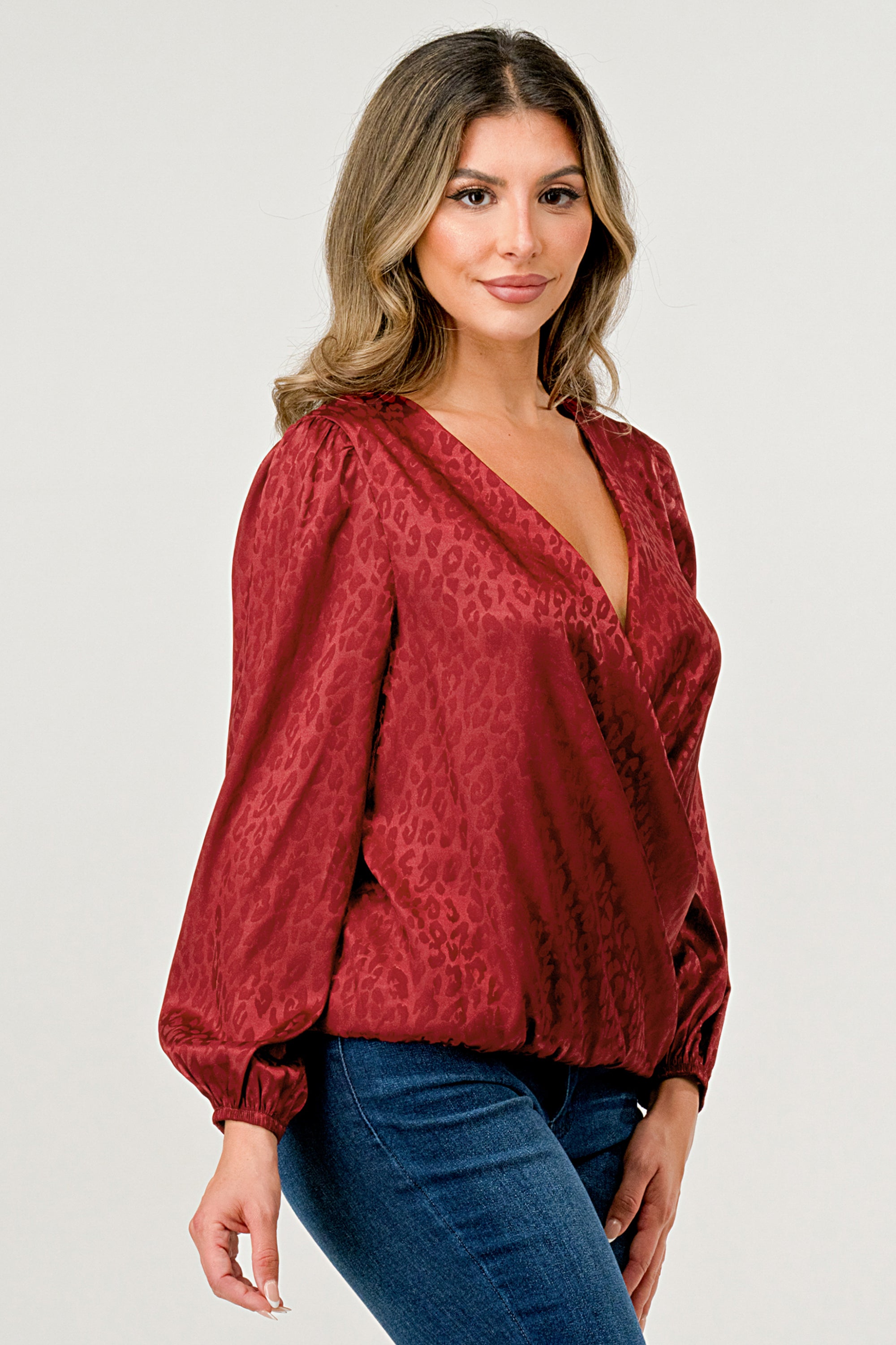 Leopard Print V-Neck Wrap Blouse with long sleeves and elastic waist, showcasing a chic satin finish and elegant jacquard pattern.