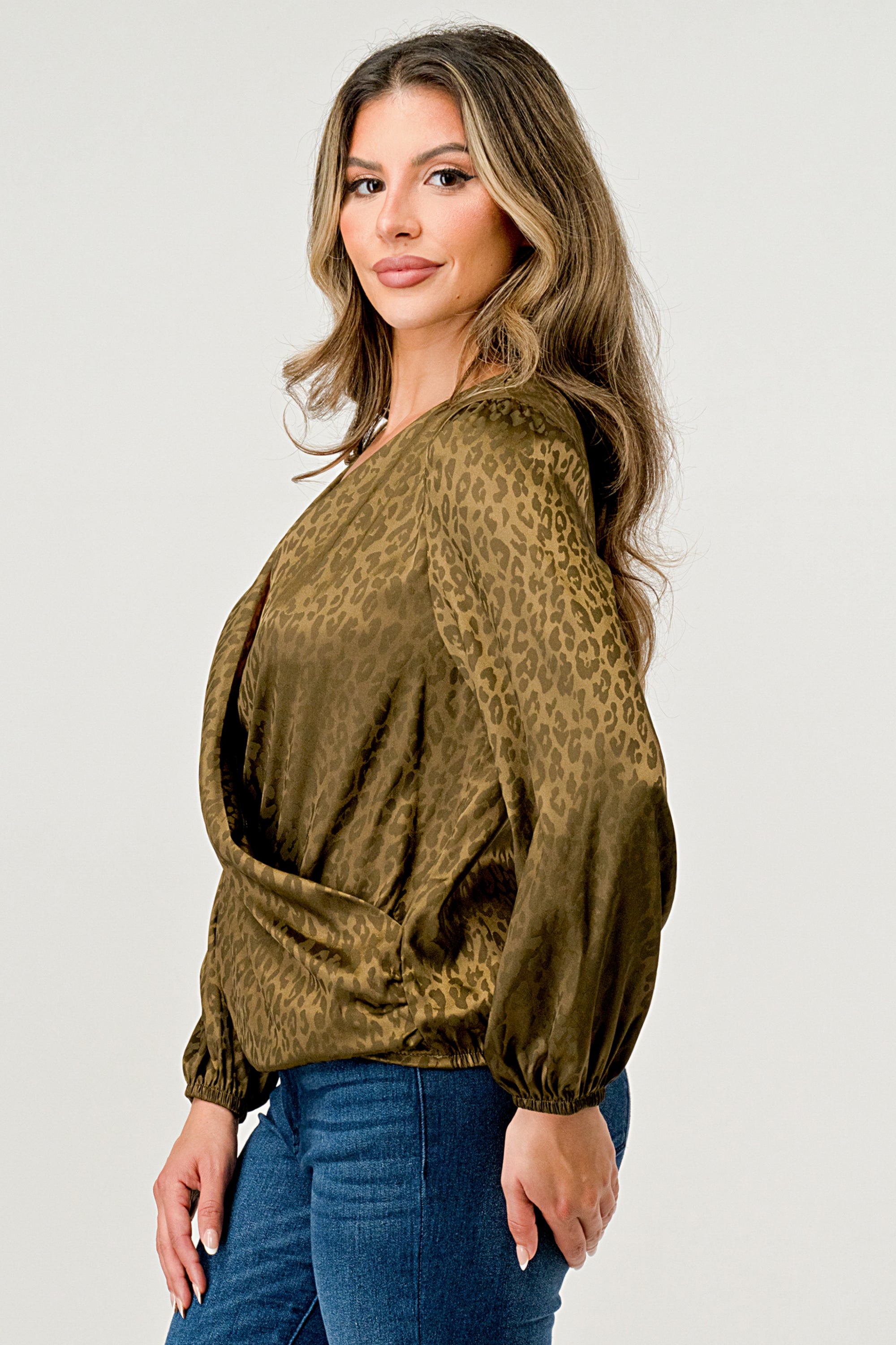 Leopard Print V-Neck Wrap Blouse with long sleeves and elastic waist, showcasing a chic satin finish and elegant jacquard pattern.