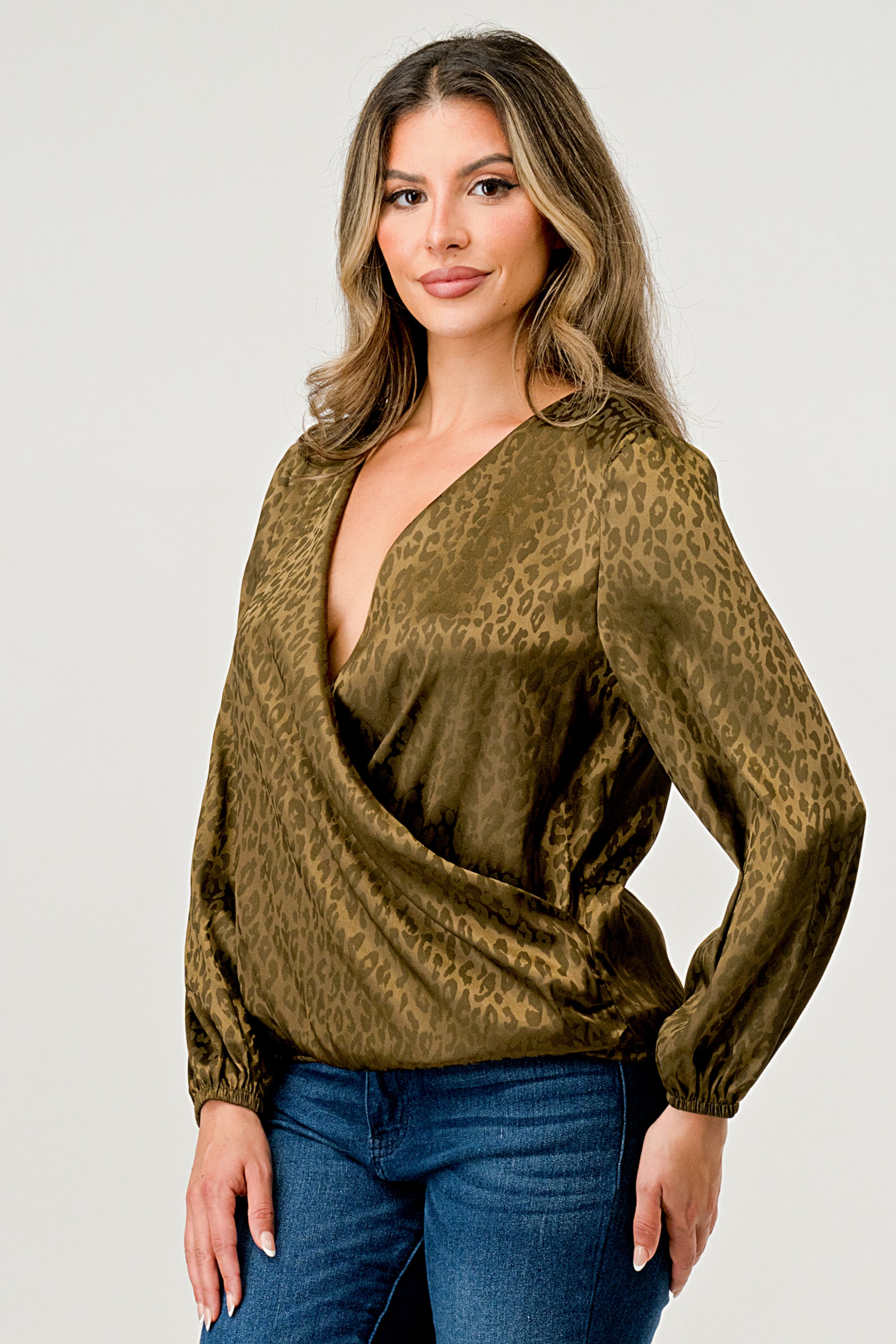 Leopard Print V-Neck Wrap Blouse with long sleeves and elastic waist, showcasing a chic satin finish and elegant jacquard pattern.