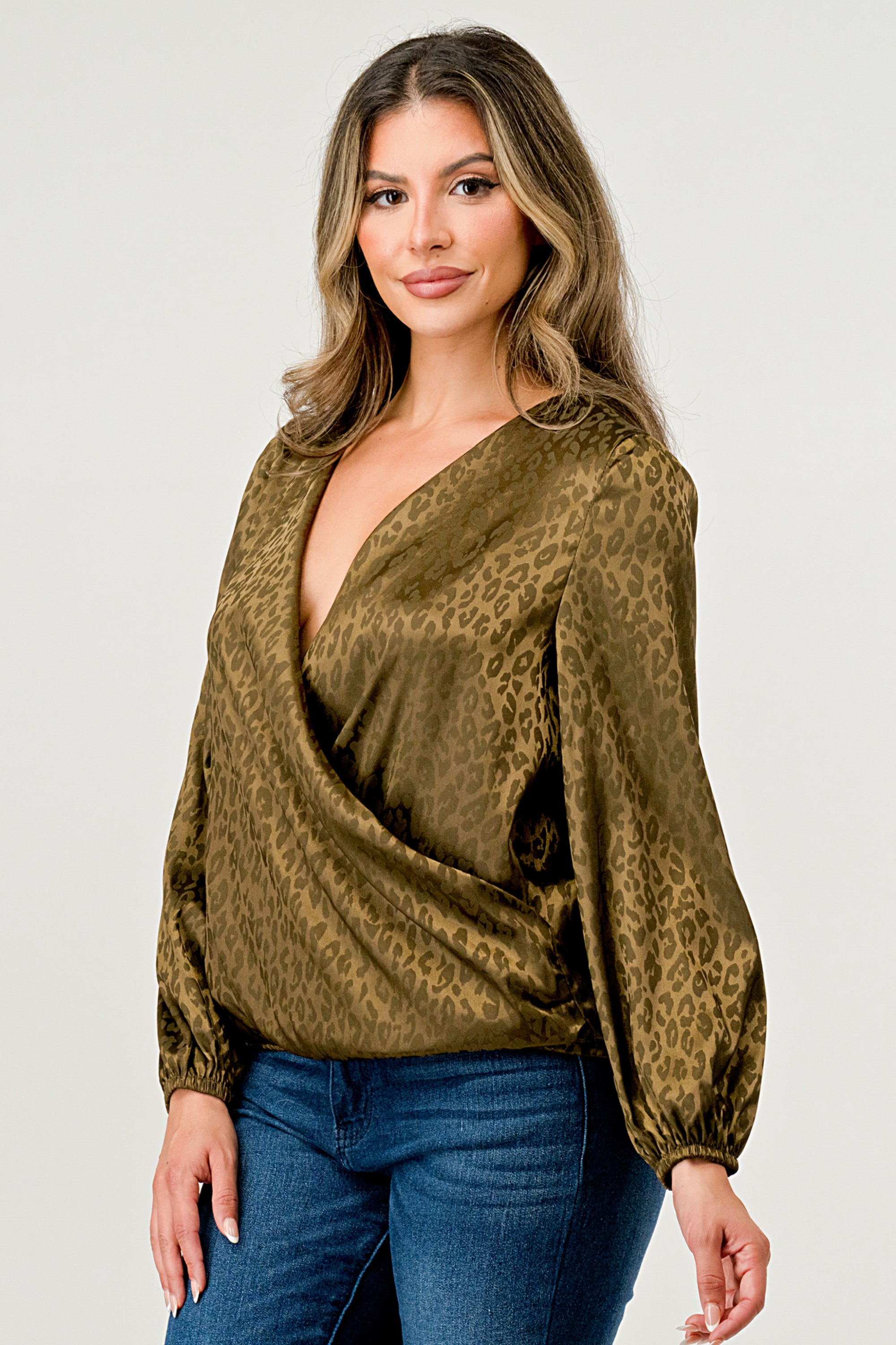 Leopard Print V-Neck Wrap Blouse with long sleeves and elastic waist, showcasing a chic satin finish and elegant jacquard pattern.