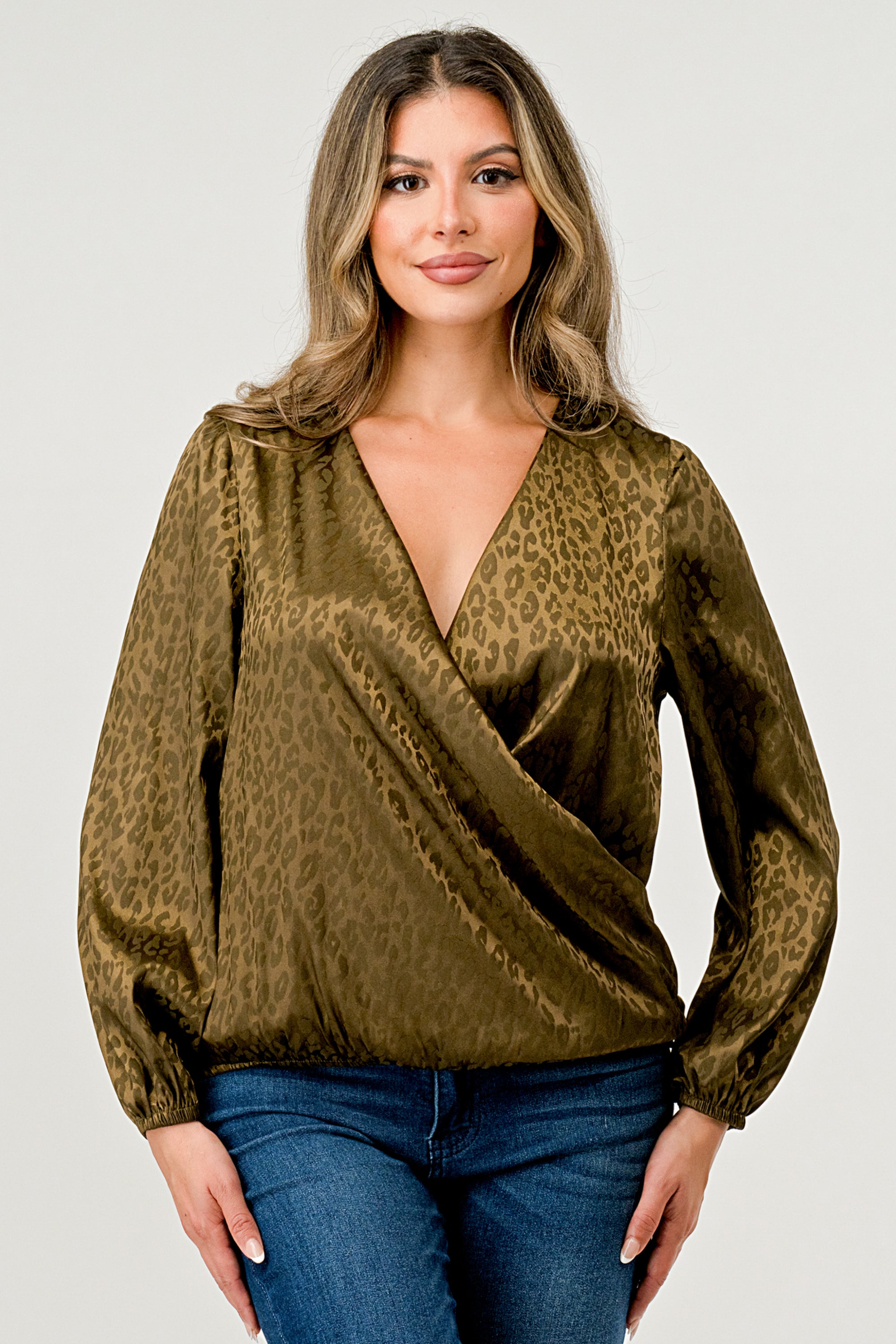 Leopard Print V-Neck Wrap Blouse with long sleeves and elastic waist, showcasing a chic satin finish and elegant jacquard pattern.