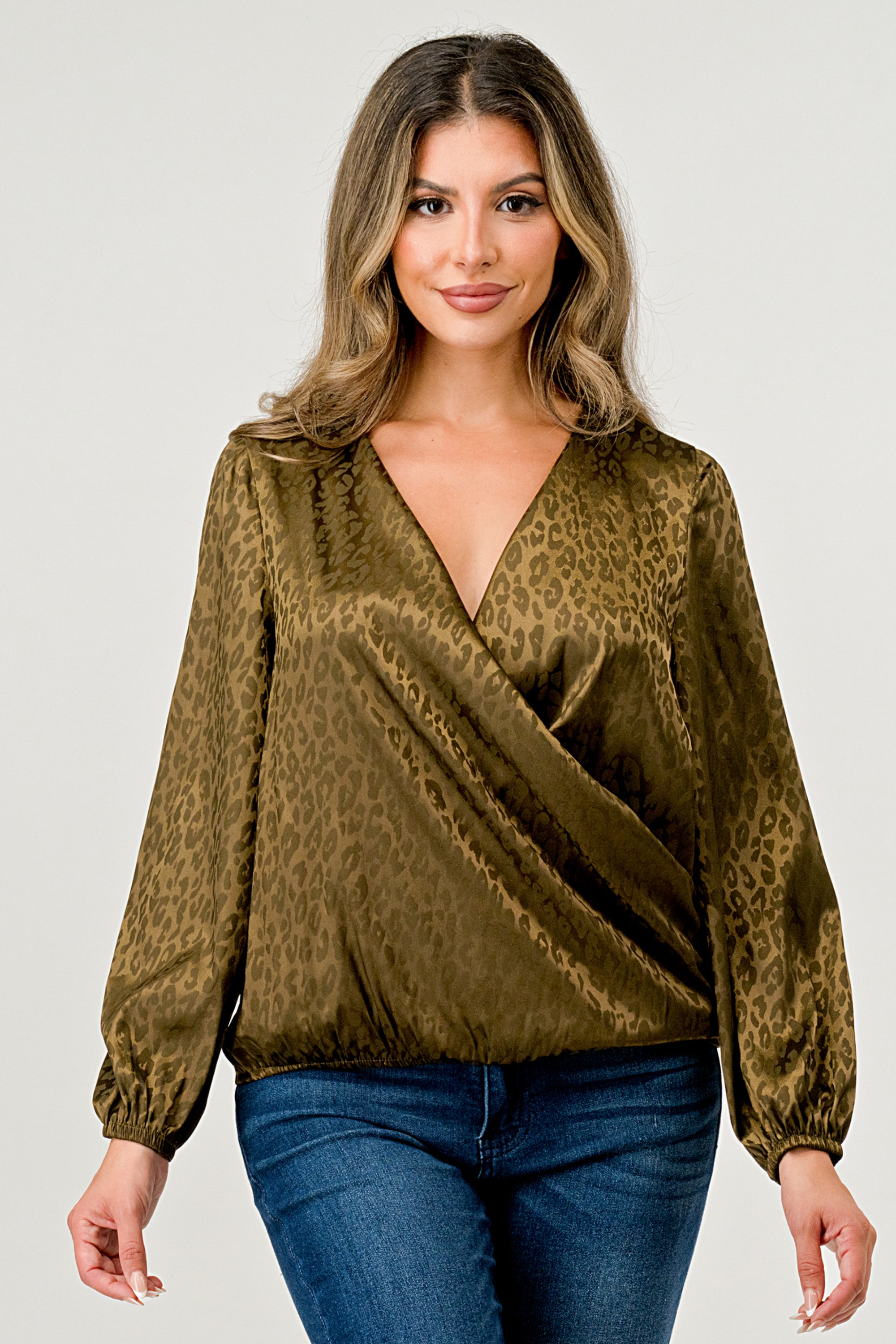 Leopard Print V-Neck Wrap Blouse with long sleeves and elastic waist, showcasing a chic satin finish and elegant jacquard pattern.