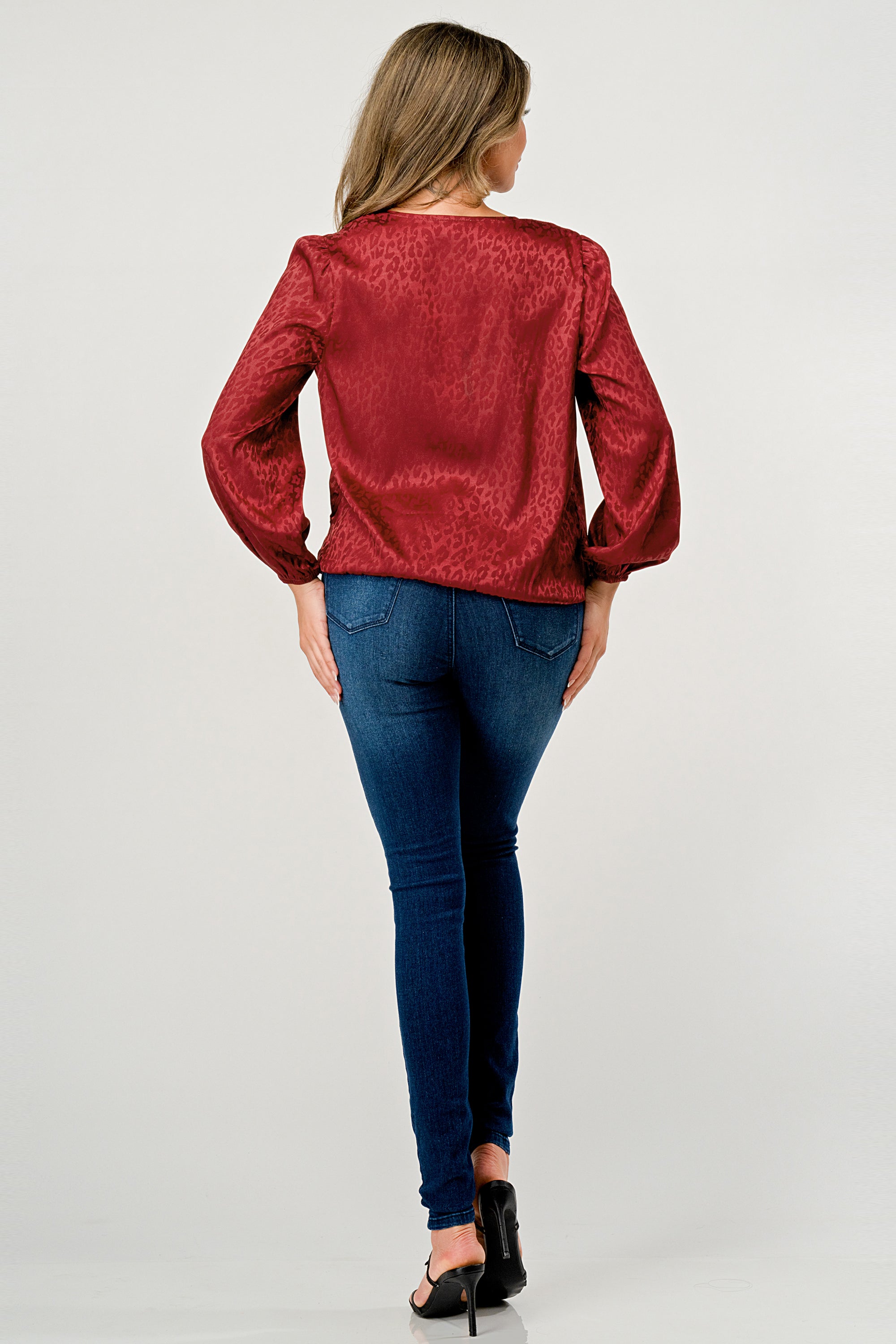 Leopard Print V-Neck Wrap Blouse with long sleeves and elastic waist, showcasing a chic satin finish and elegant jacquard pattern.