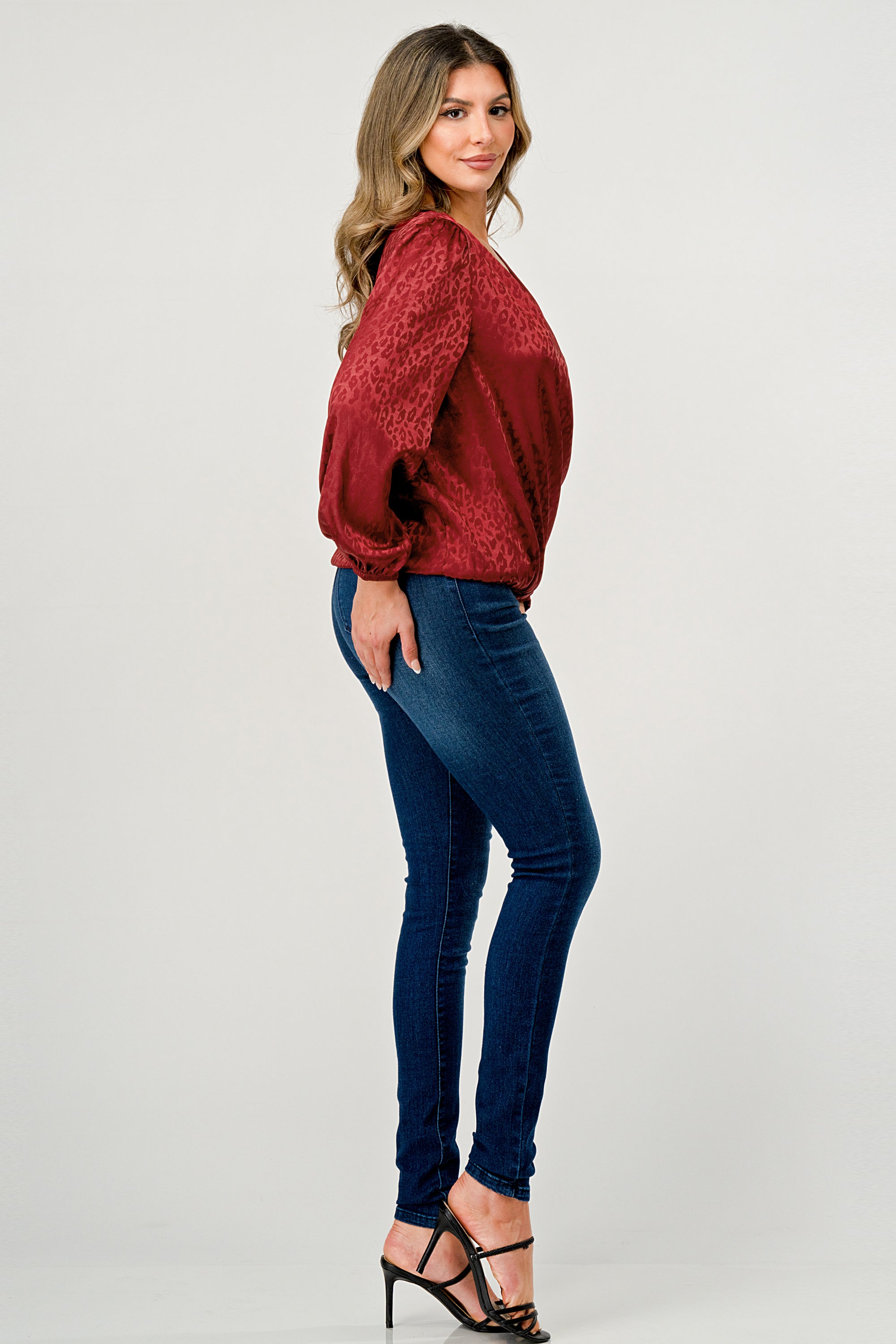 Leopard Print V-Neck Wrap Blouse with long sleeves and elastic waist, showcasing a chic satin finish and elegant jacquard pattern.