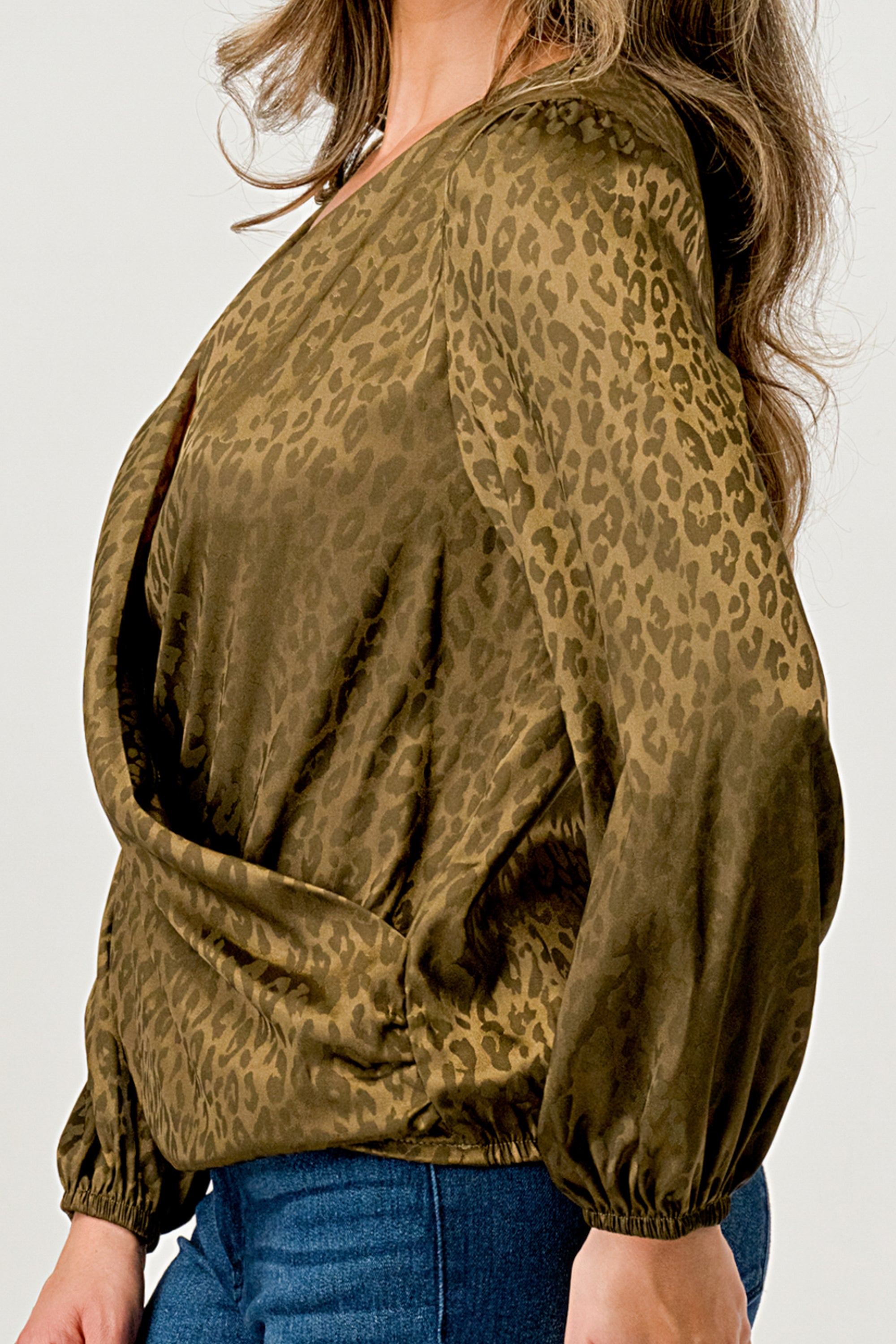 Leopard Print V-Neck Wrap Blouse with long sleeves and elastic waist, showcasing a chic satin finish and elegant jacquard pattern.