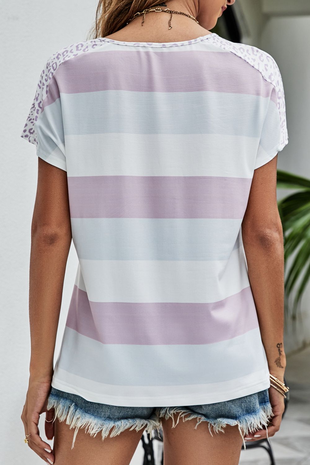 Leopard Striped V-Neck Tee Shirt displayed outdoors, showcasing its trendy design and casual style.