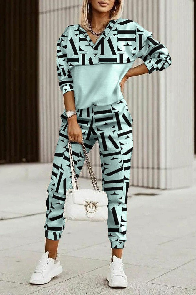 Mint green faux velvet tracksuit featuring letter print sweatshirt and long pants with pockets.