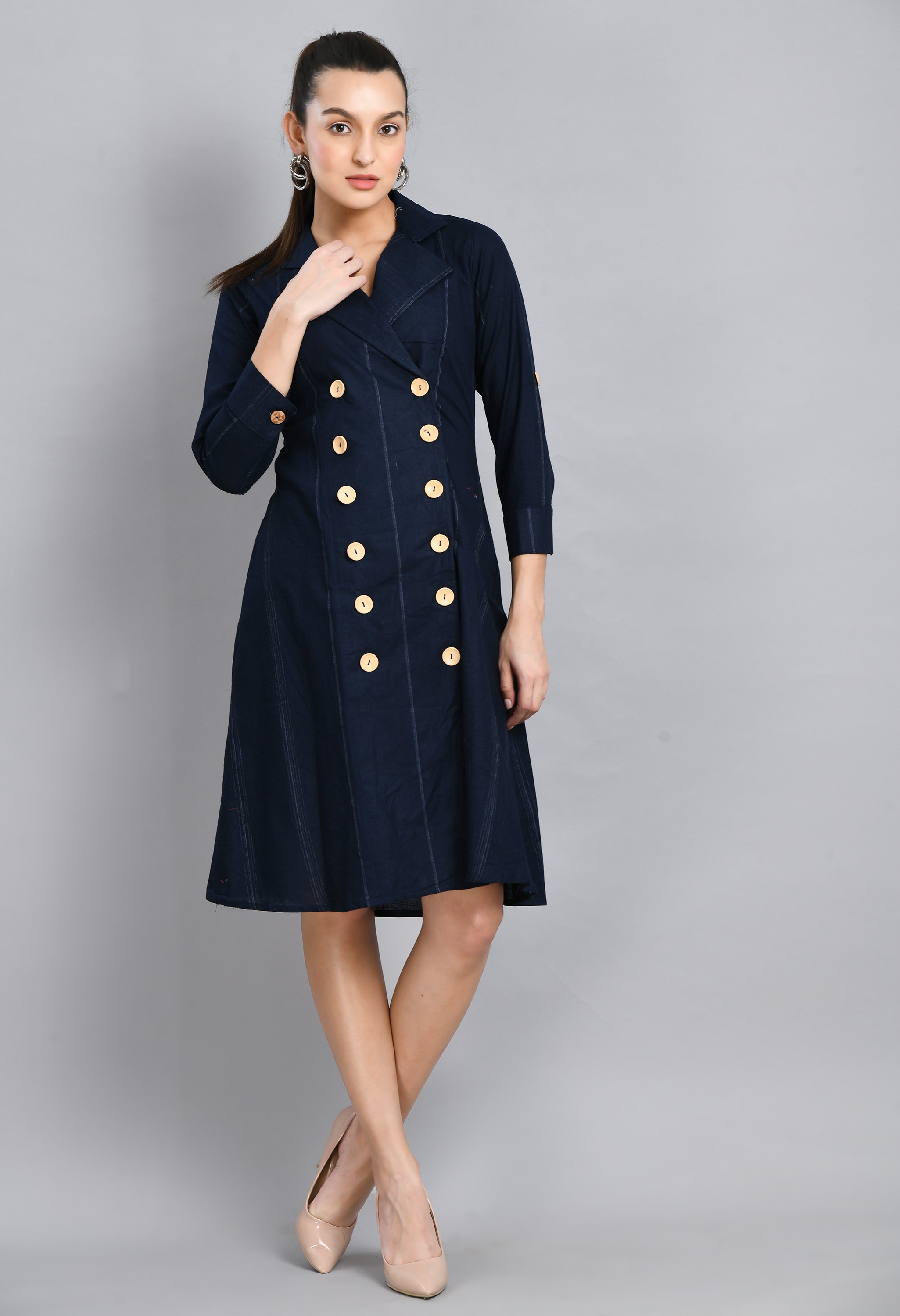 A stylish blue linen jacket dress featuring roll-up sleeves, collared neck, and asymmetrical hem, perfect for casual and semi-festive occasions.