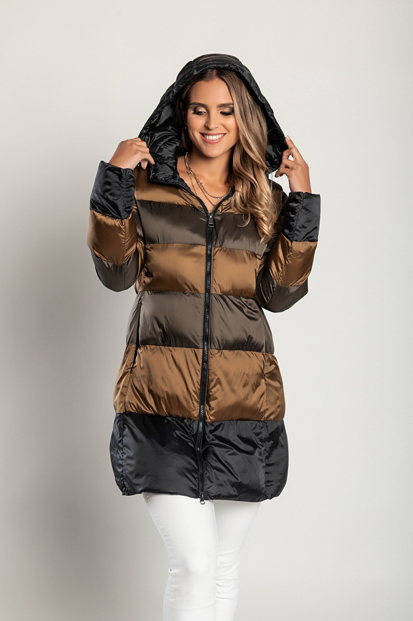 Long camel jacket with hood, high collar, and zip closure, showcasing its stylish design and warm filling.