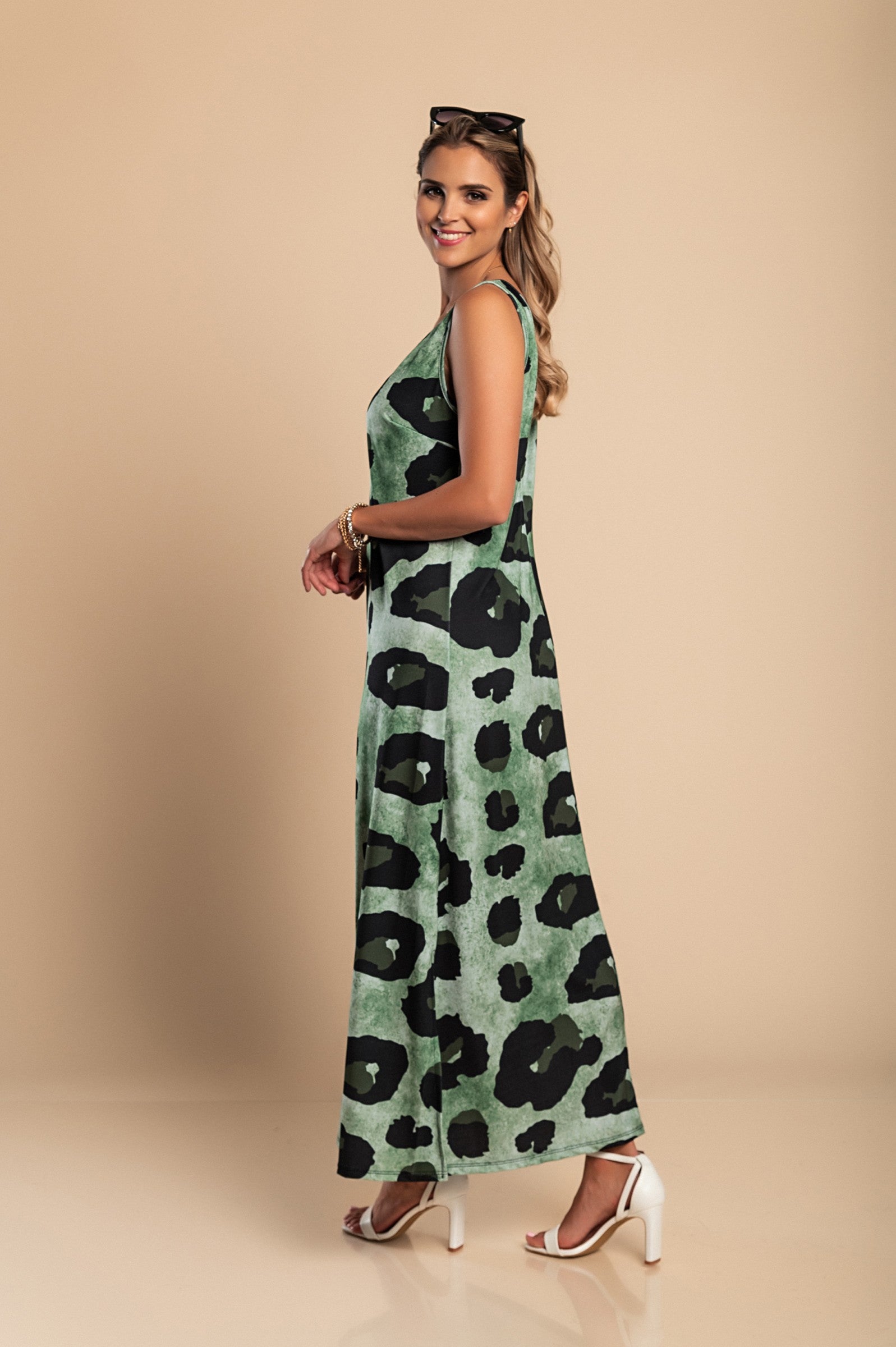 Elegant long green leopard print dress with round neckline and side slit, made from lightweight fabric.