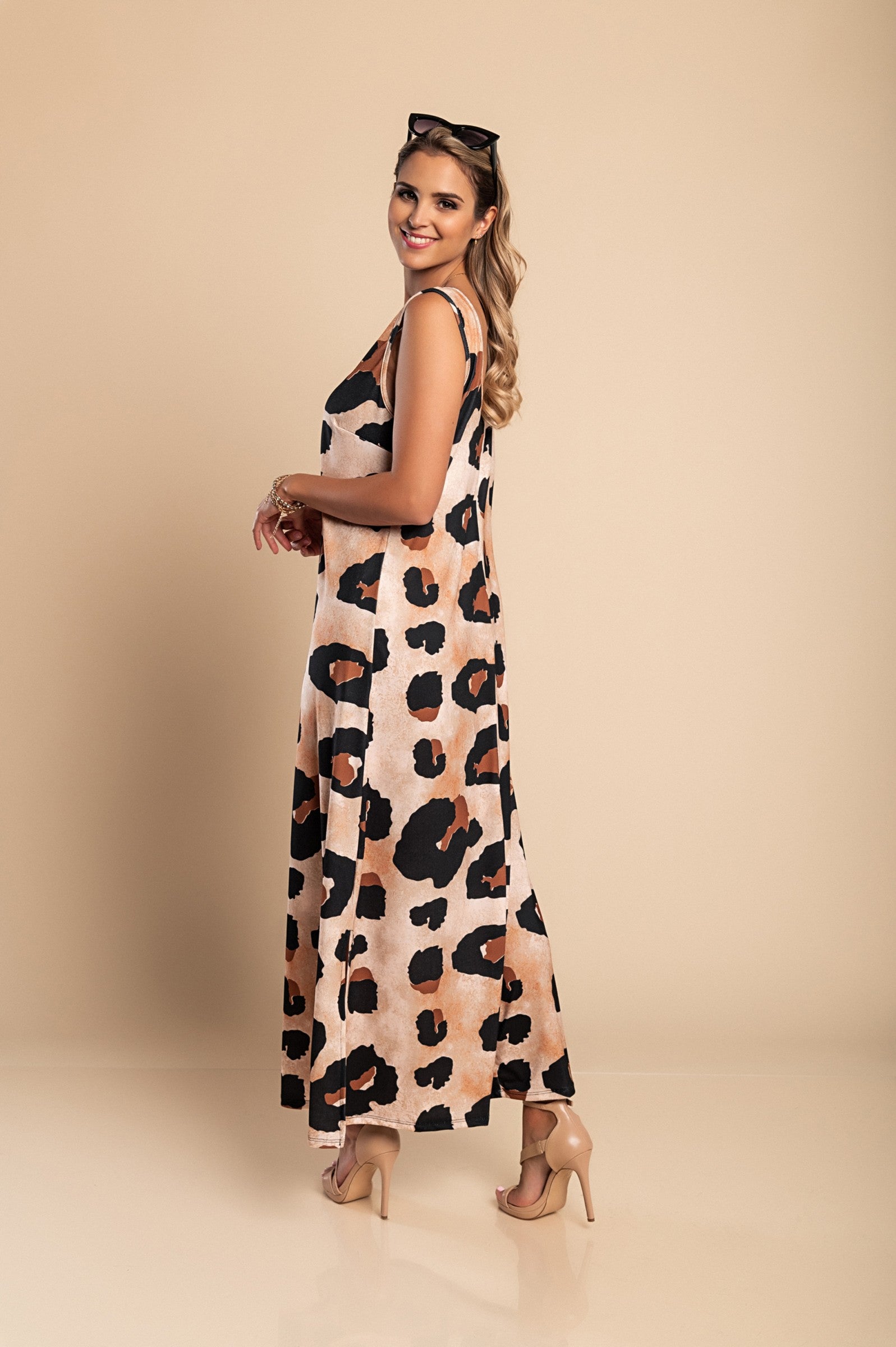 Elegant long leopard print dress with round neckline and side slit, made from lightweight fabric.
