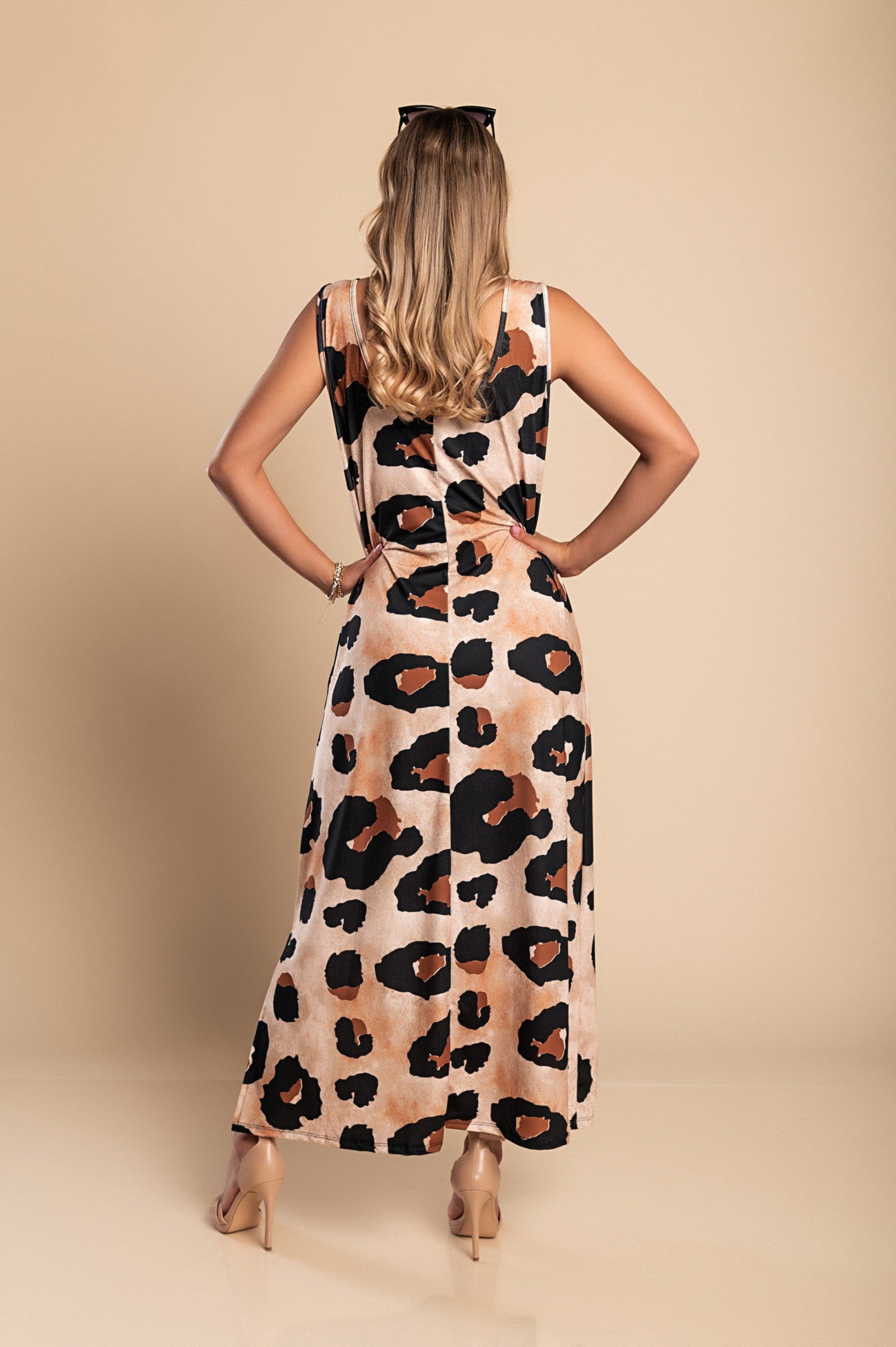 Elegant long leopard print dress with round neckline and side slit, made from lightweight fabric.