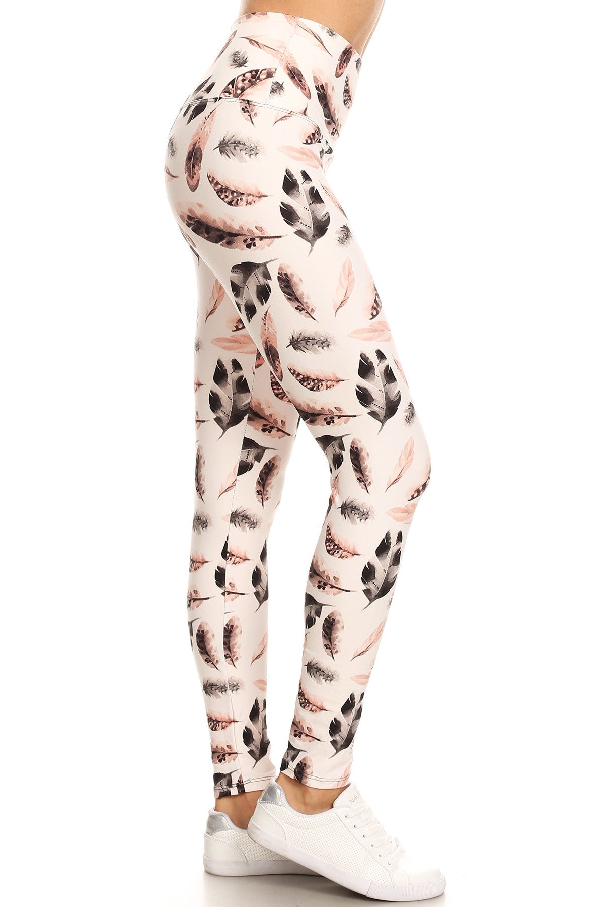 Long yoga style leggings featuring a banded waist and leaf print design, made from a comfortable knit fabric.