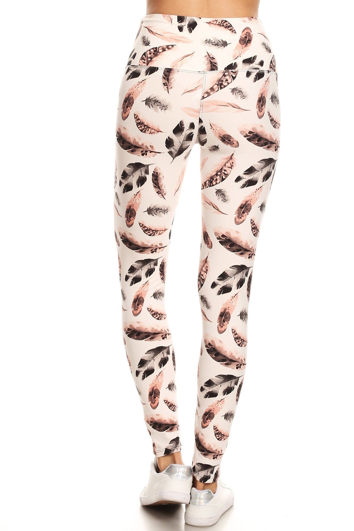 Long yoga style leggings featuring a banded waist and leaf print design, made from a comfortable knit fabric.