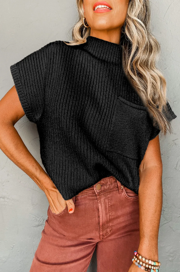 Loose knitted black top with short sleeves and decorative front pocket, showcasing a high neck design.