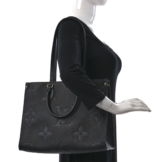 LOUIS VUITTON Empreinte Monogram Giant Onthego MM Black tote bag featuring oversized monogram print, rolled leather handles, and gold hardware.
