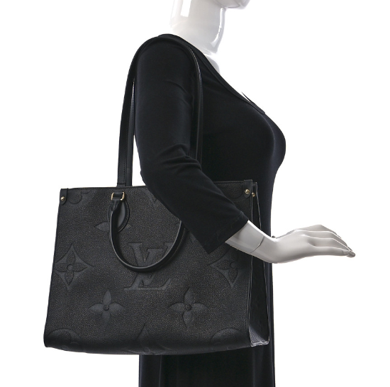 LOUIS VUITTON Empreinte Monogram Giant Onthego MM Black tote bag featuring oversized monogram print, rolled leather handles, and gold hardware.