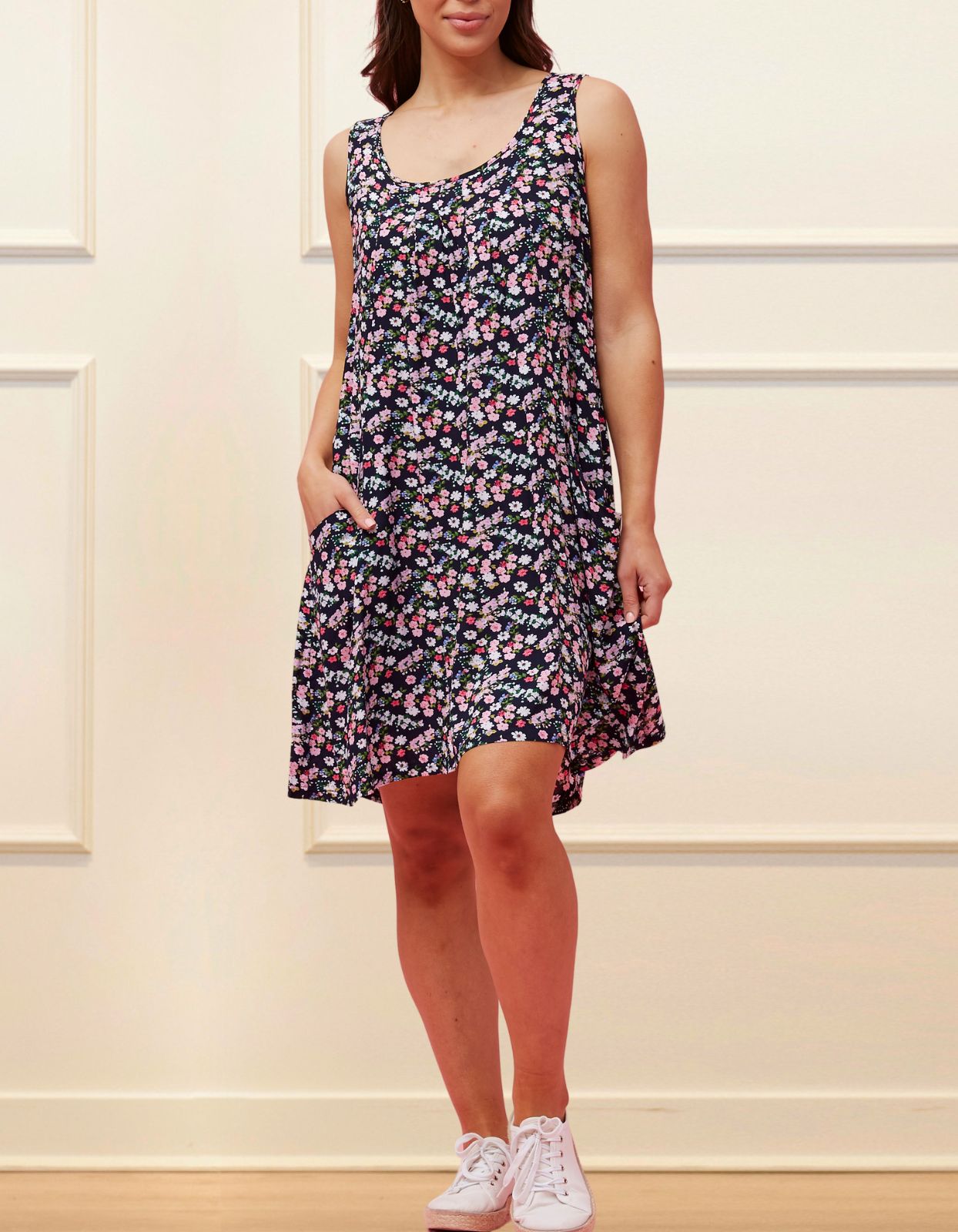 Louise Short Dress featuring a ditsy floral print in Navy, Red, and Green, showcasing a flattering A-line silhouette and side pockets.