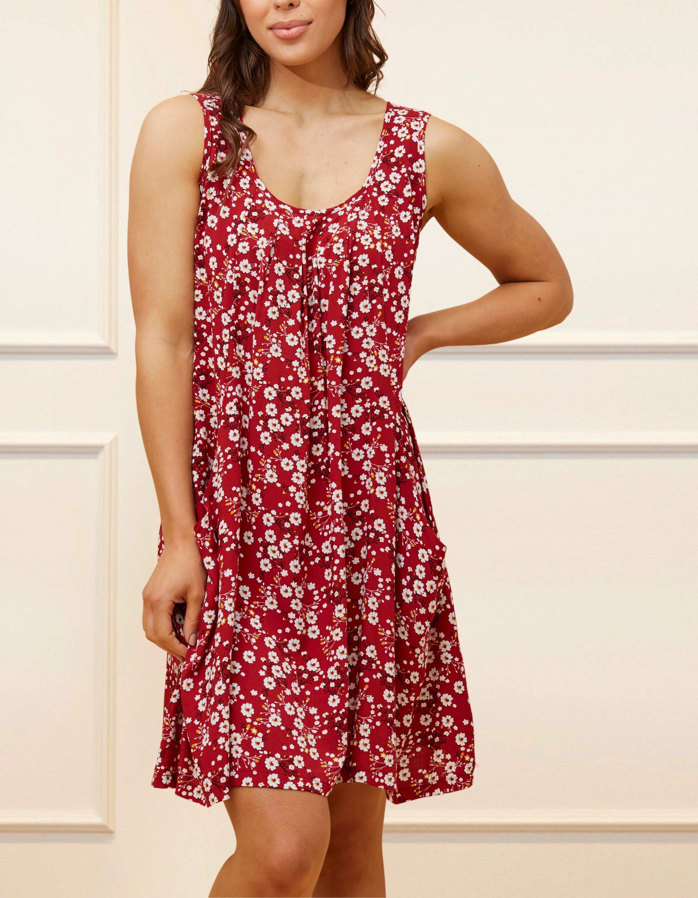 Louise Short Dress featuring a ditsy floral print in Navy, Red, and Green, showcasing a flattering A-line silhouette and side pockets.