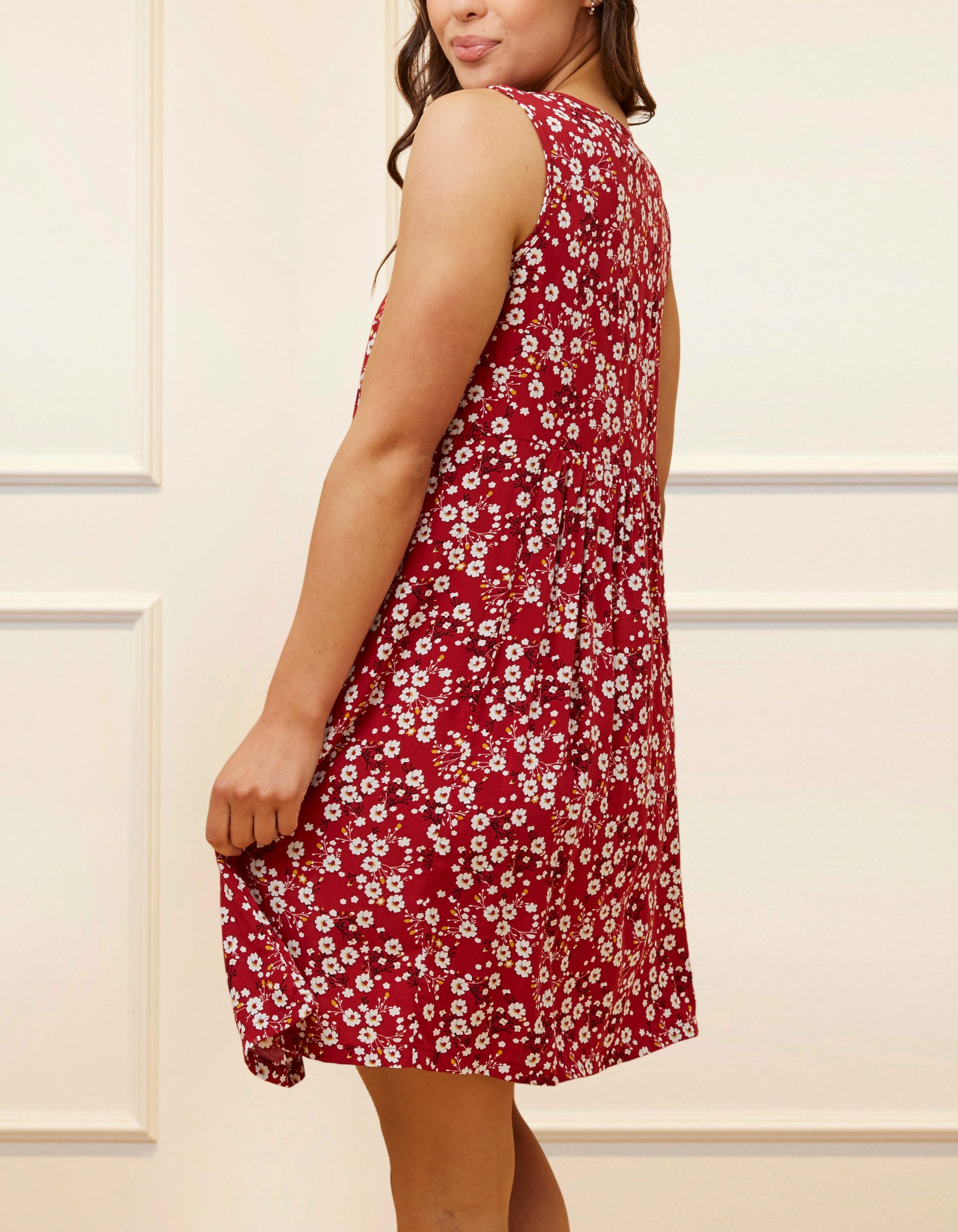 Louise Short Dress featuring a ditsy floral print in Navy, Red, and Green, showcasing a flattering A-line silhouette and side pockets.