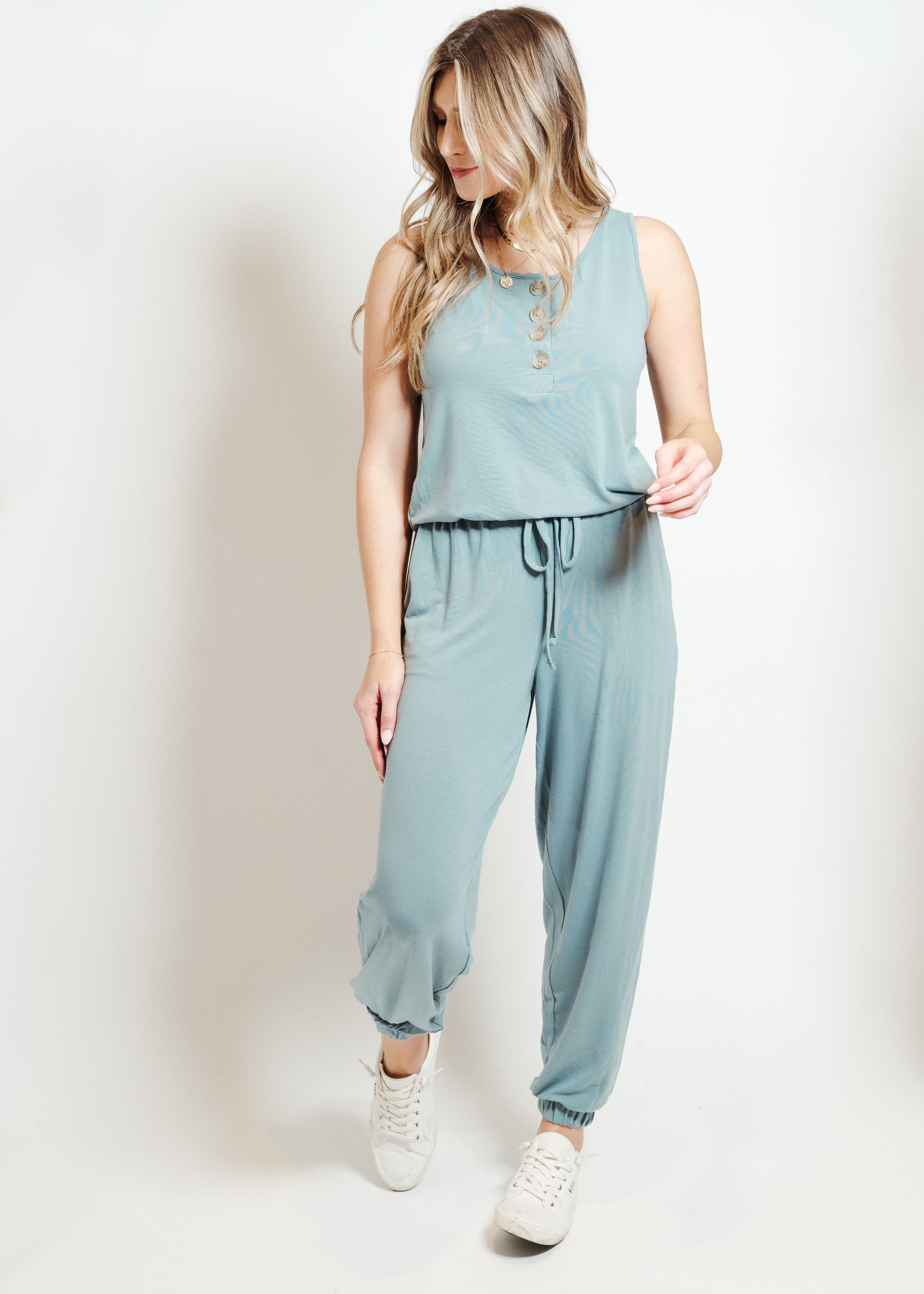 A stylish blue gray lounge jumpsuit displayed on a mannequin, showcasing its comfortable fit and versatile design.