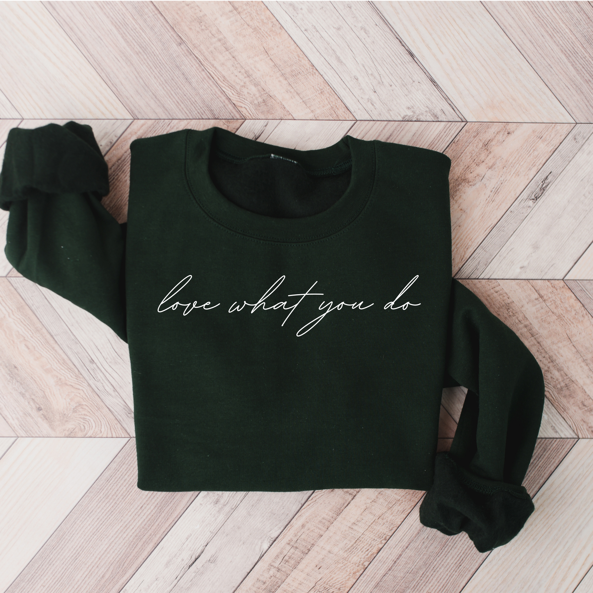 A stylish unisex sweatshirt featuring the motivational phrase 'Love What You Do' in bold lettering, perfect for casual wear.