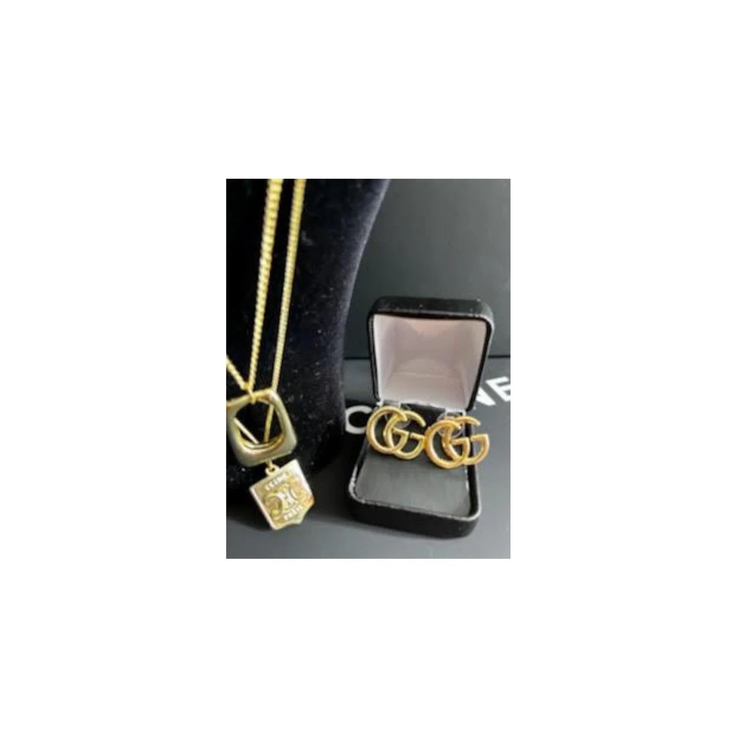 A pair of luxurious gold earrings featuring a beautiful GG design, showcasing high-quality craftsmanship and elegant style.