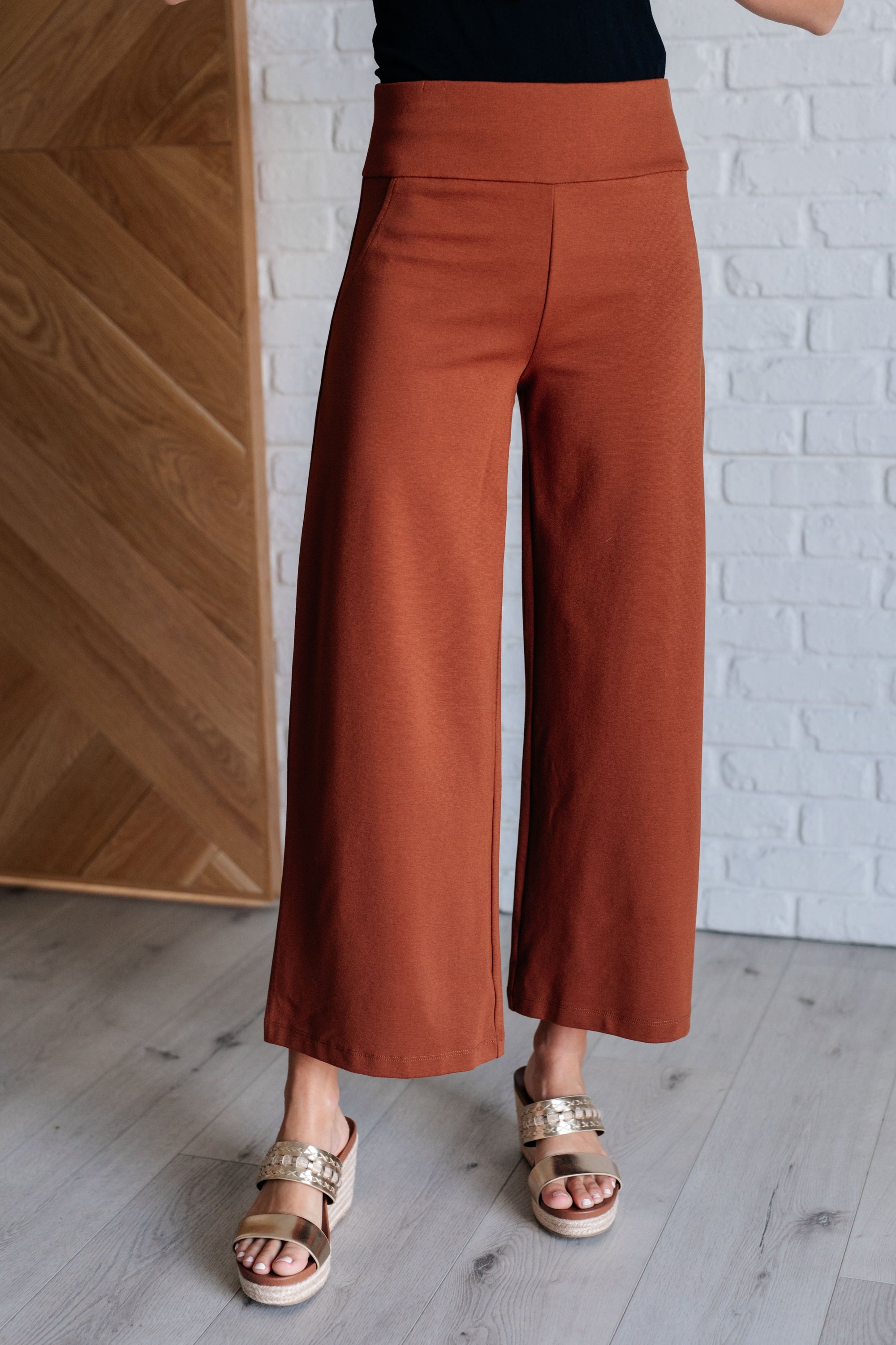 Magic Wide Leg Crop Pants in Rust, showcasing a trendy cropped design with a faux welt pocket, made from high stretch ponte knit fabric.
