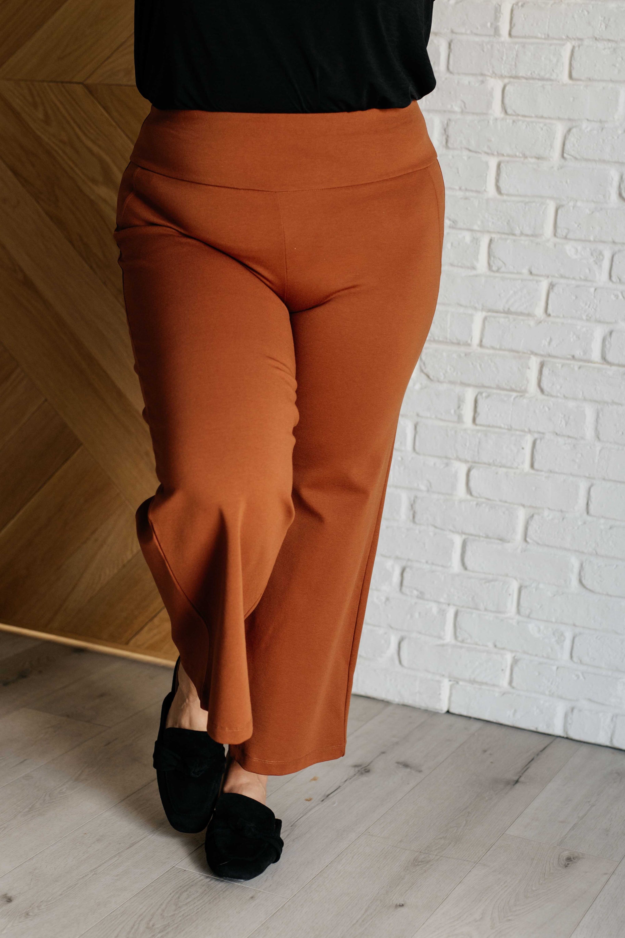 Magic Wide Leg Crop Pants in Rust, showcasing a trendy cropped design with a faux welt pocket, made from high stretch ponte knit fabric.