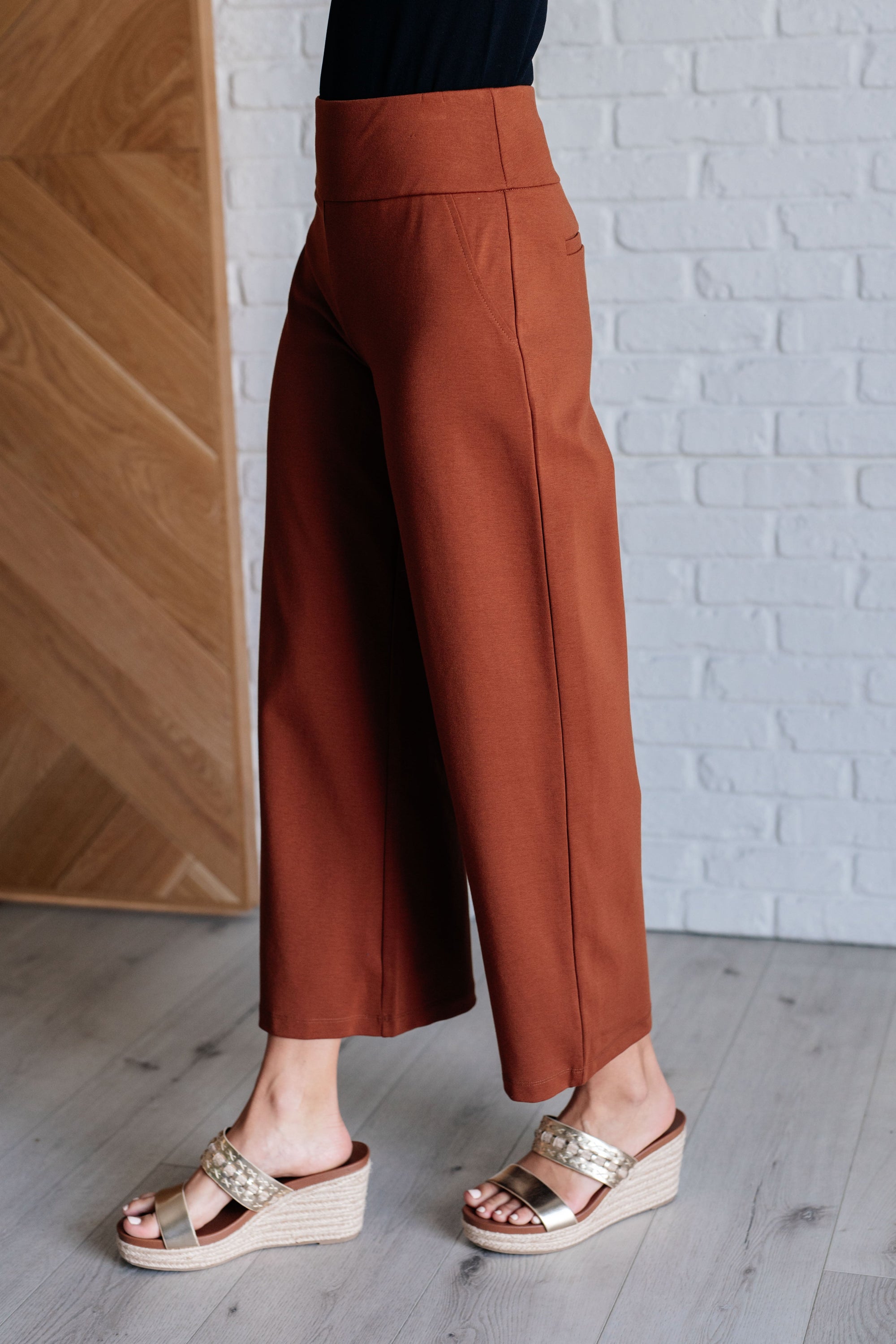 Magic Wide Leg Crop Pants in Rust, showcasing a trendy cropped design with a faux welt pocket, made from high stretch ponte knit fabric.