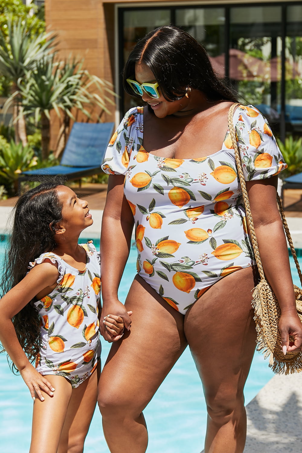 Marina West Swim Float On Ruffled One-Piece in vibrant citrus orange with stylish ruffle detailing, perfect for beach and pool activities.