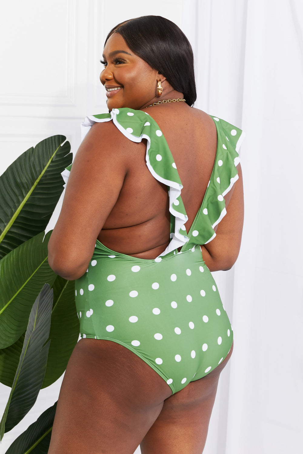 Marina West Swim Moonlit Dip Ruffle Plunge Swimsuit in Mid Green featuring a deep plunge neckline and ruffle trim, perfect for beach outings.