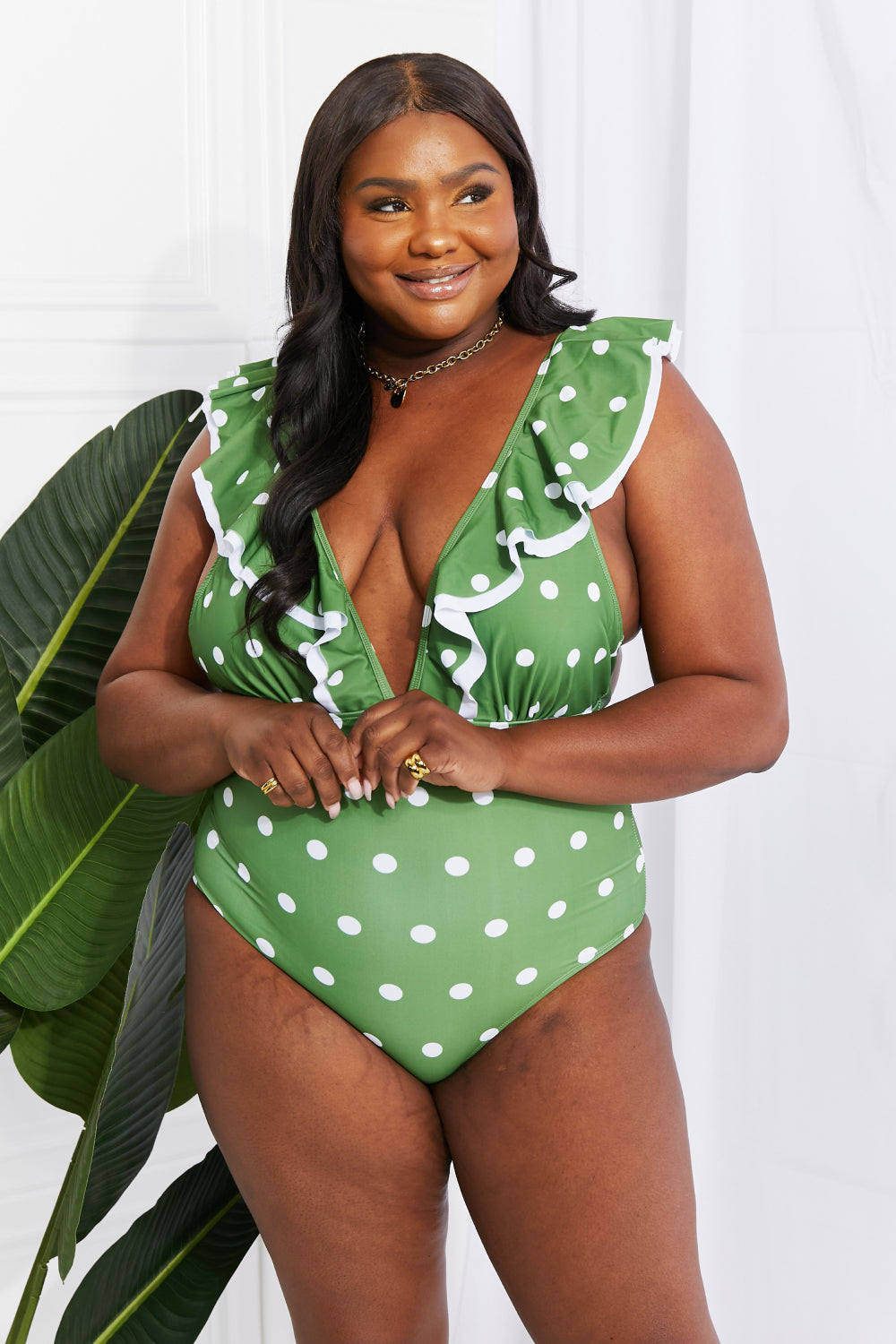 Marina West Swim Moonlit Dip Ruffle Plunge Swimsuit in Mid Green featuring a deep plunge neckline and ruffle trim, perfect for beach outings.
