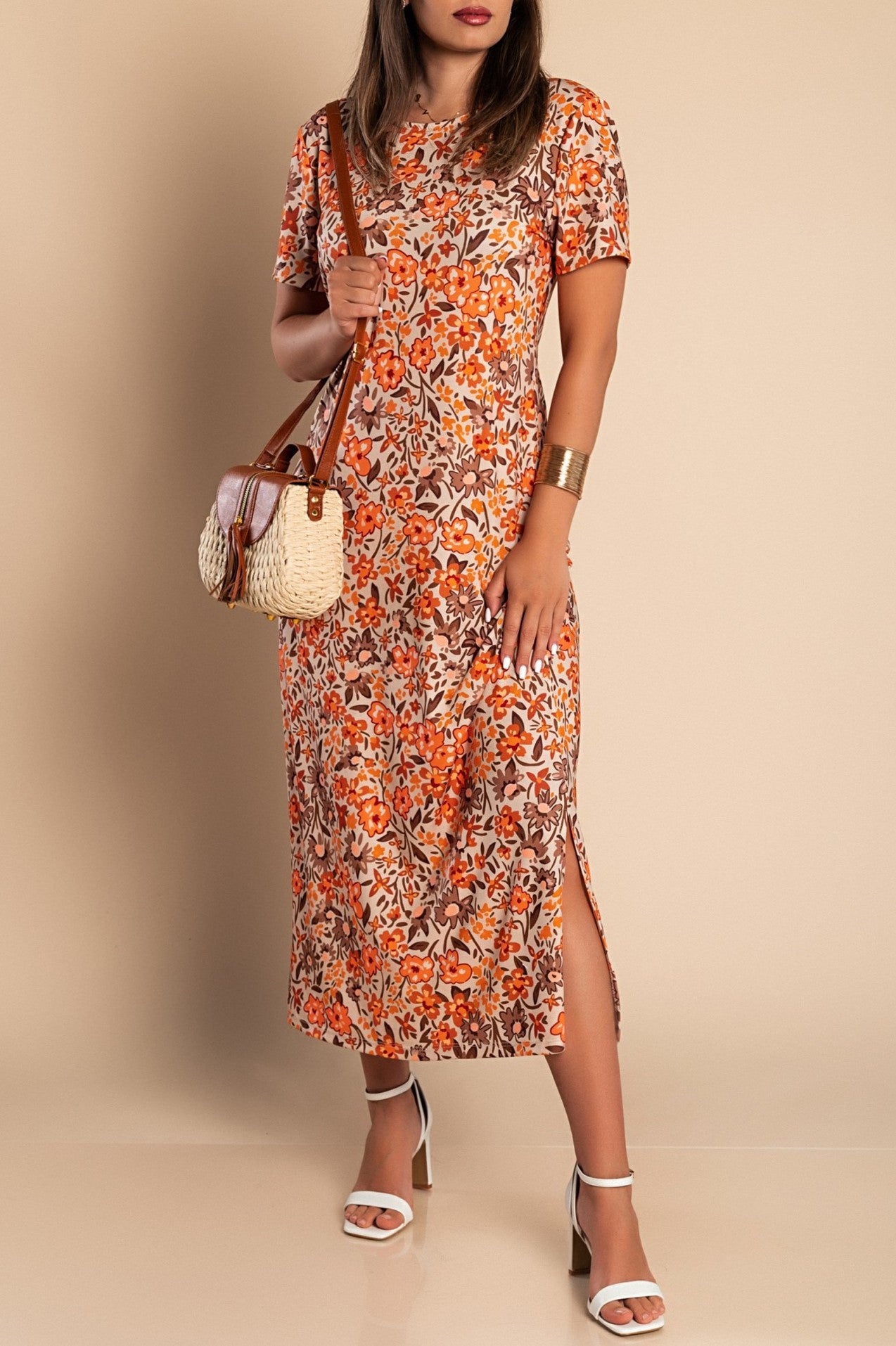 Elegant orange maxi dress with floral print, featuring a round neckline and short sleeves, made in Italy.