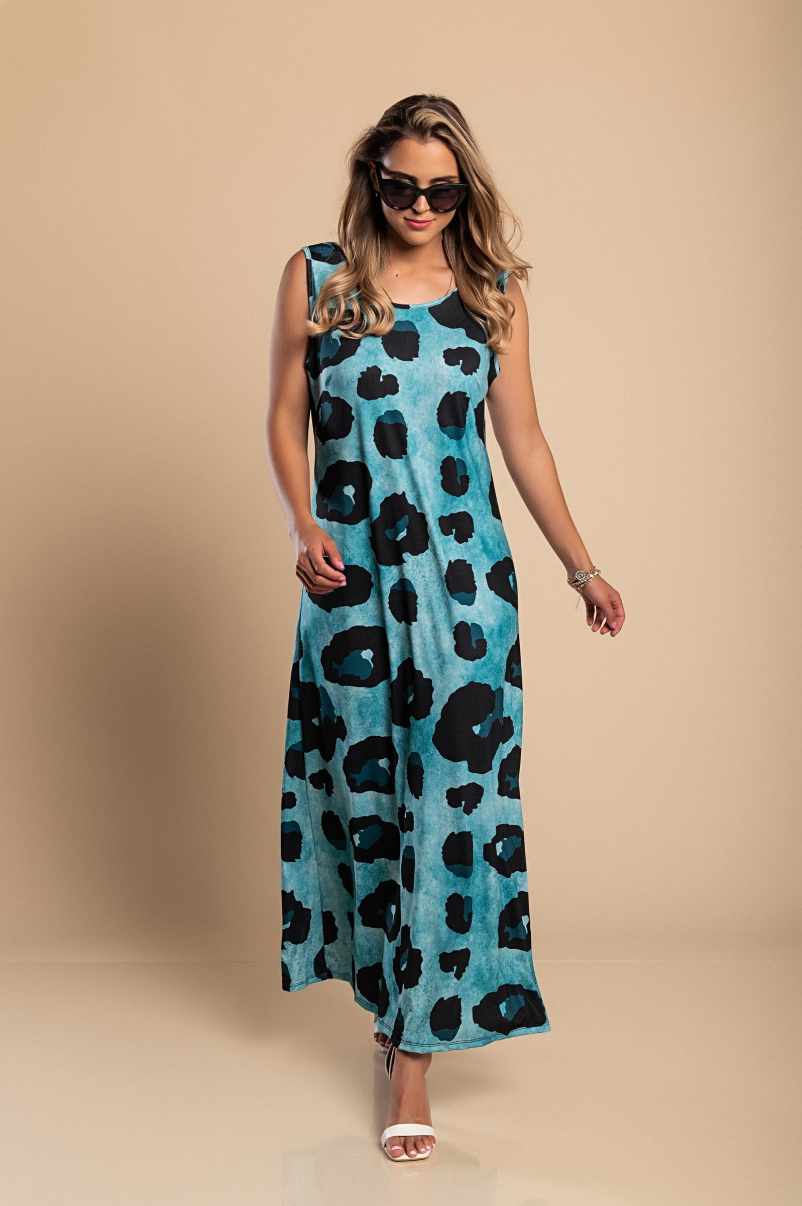 Elegant blue leopard print maxi dress with a round neckline and side slit, made from lightweight fabric.