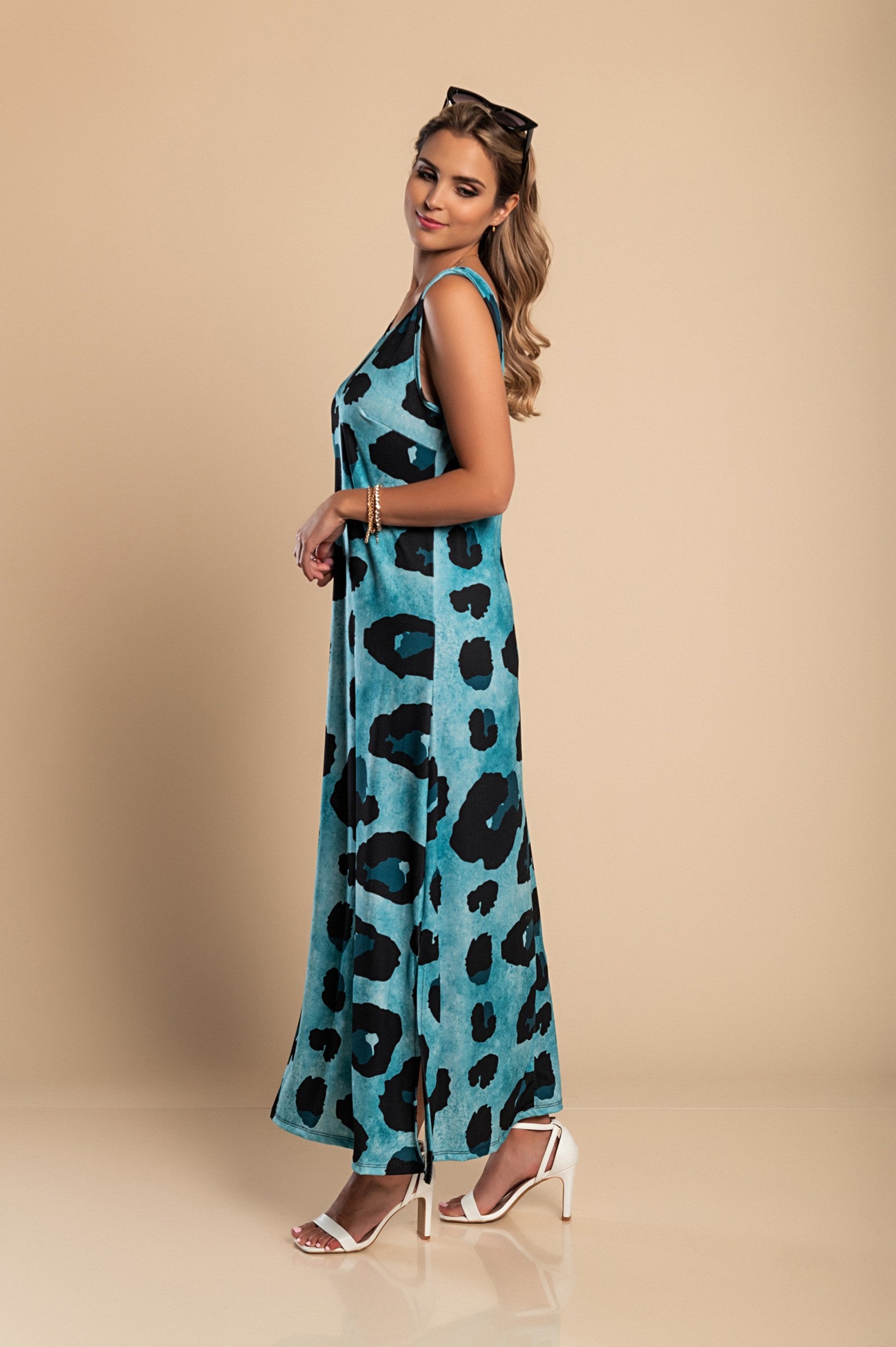 Elegant blue leopard print maxi dress with a round neckline and side slit, made from lightweight fabric.