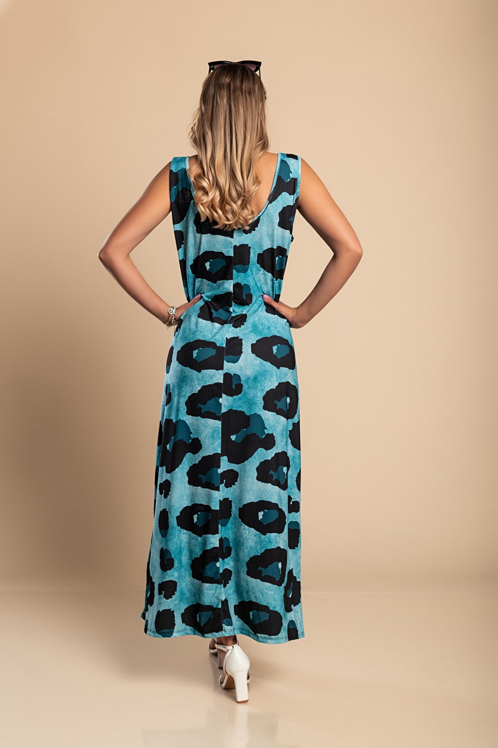 Elegant blue leopard print maxi dress with a round neckline and side slit, made from lightweight fabric.