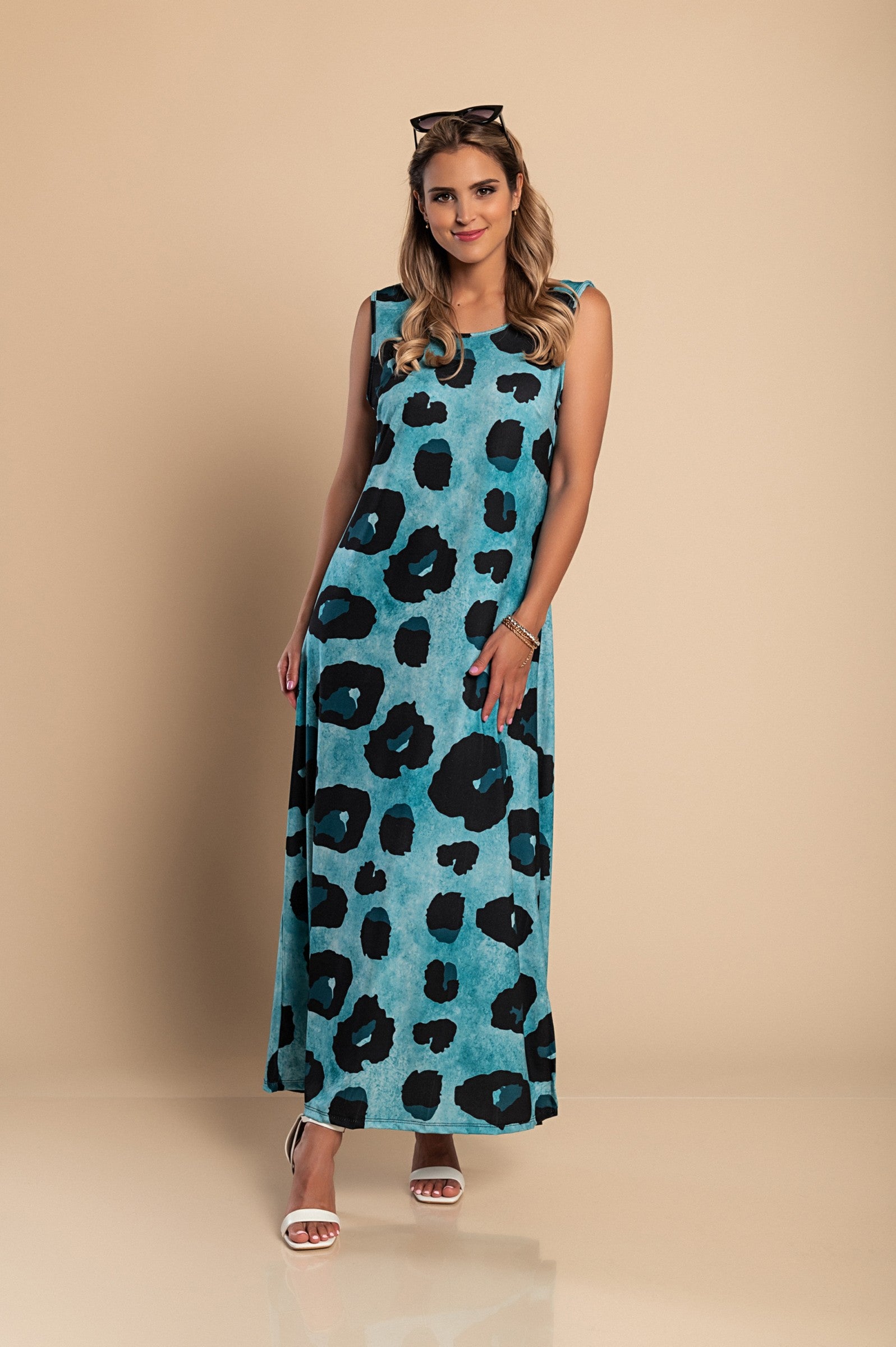 Elegant blue leopard print maxi dress with a round neckline and side slit, made from lightweight fabric.