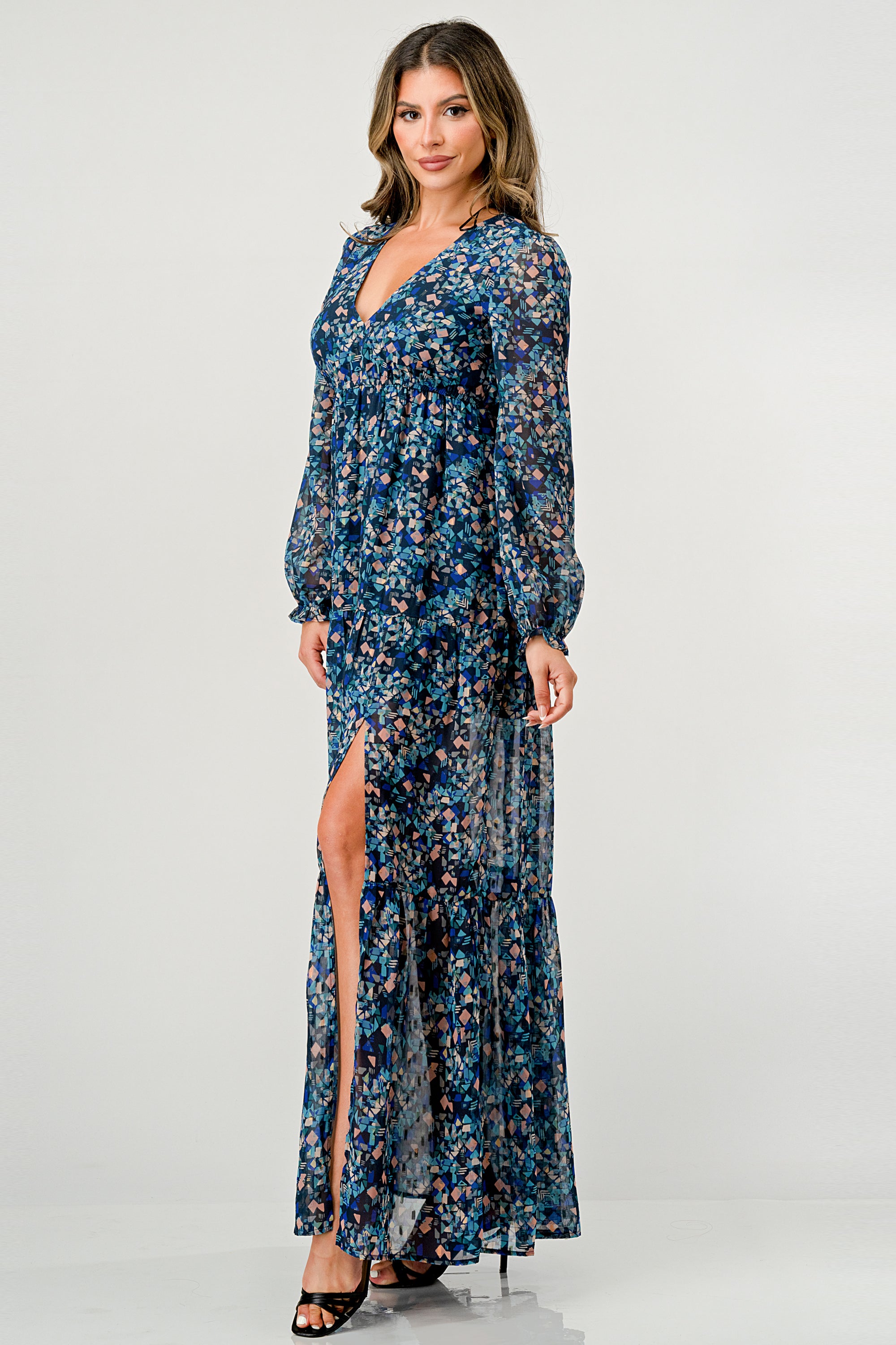 A beautiful floral print maxi dress featuring long sleeves, a V neck, and a stylish side slit, perfect for any occasion.