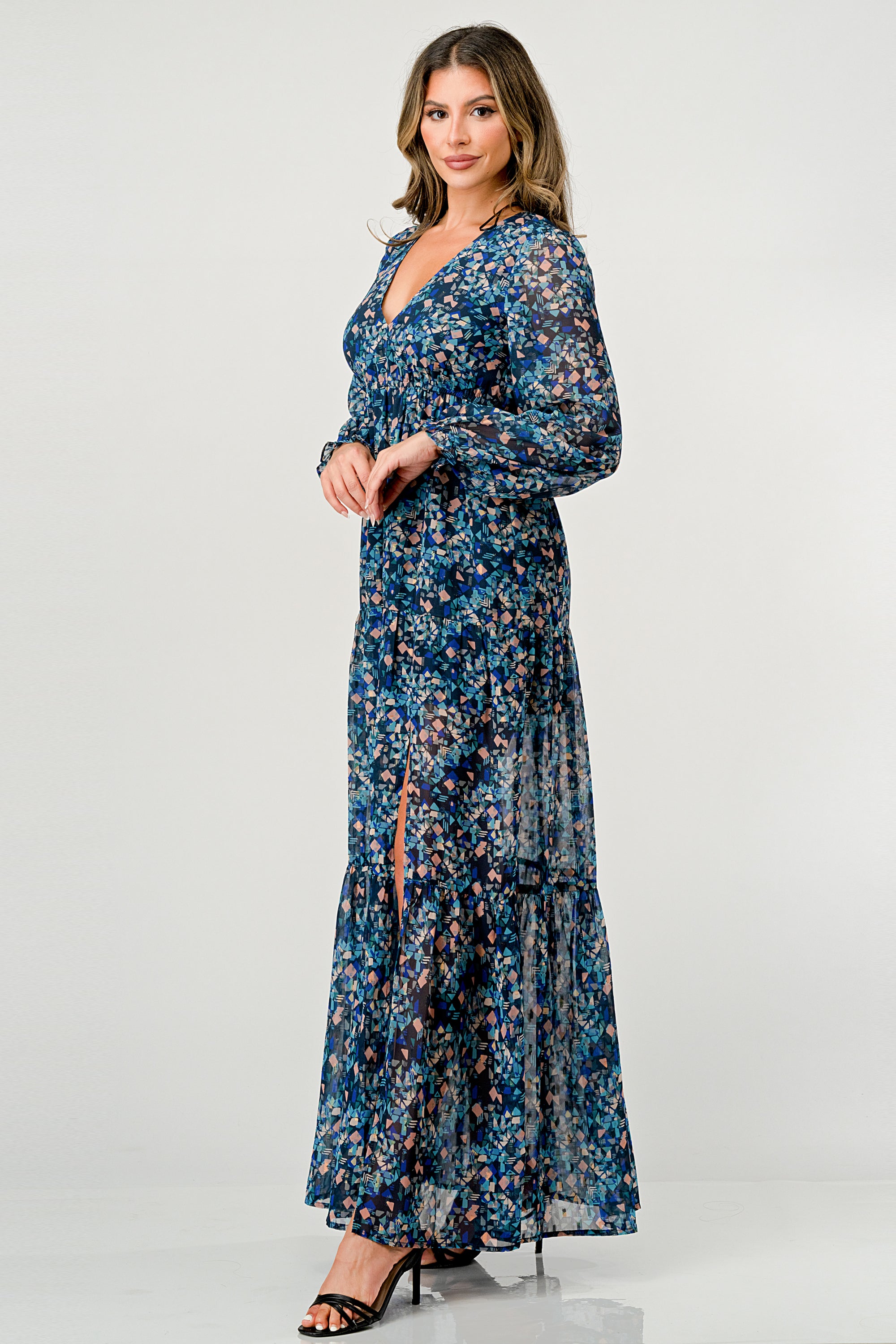 A beautiful floral print maxi dress featuring long sleeves, a V neck, and a stylish side slit, perfect for any occasion.