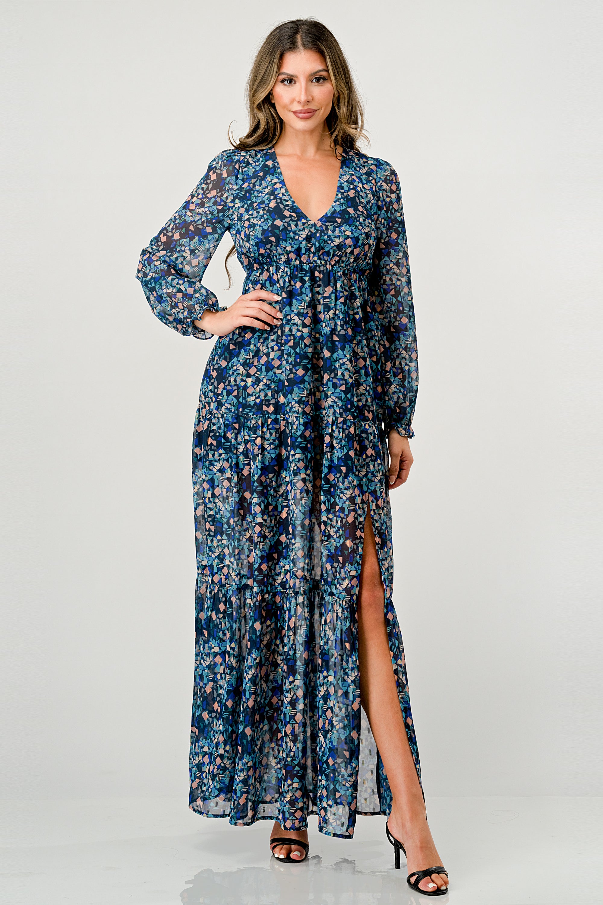 A beautiful floral print maxi dress featuring long sleeves, a V neck, and a stylish side slit, perfect for any occasion.