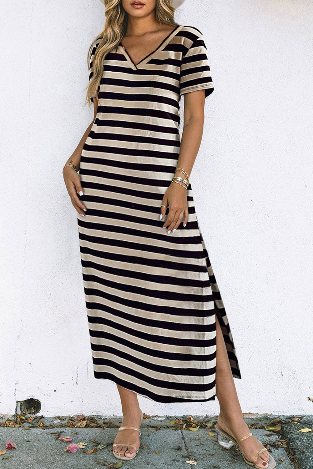 Elegant black maxi dress with striped print, featuring a V-neckline and flowing sleeves, perfect for any occasion.