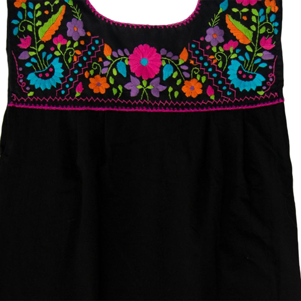 Maxi Isidra black dress featuring colorful hand-embroidered flowers, showcasing intricate craftsmanship and bohemian style.