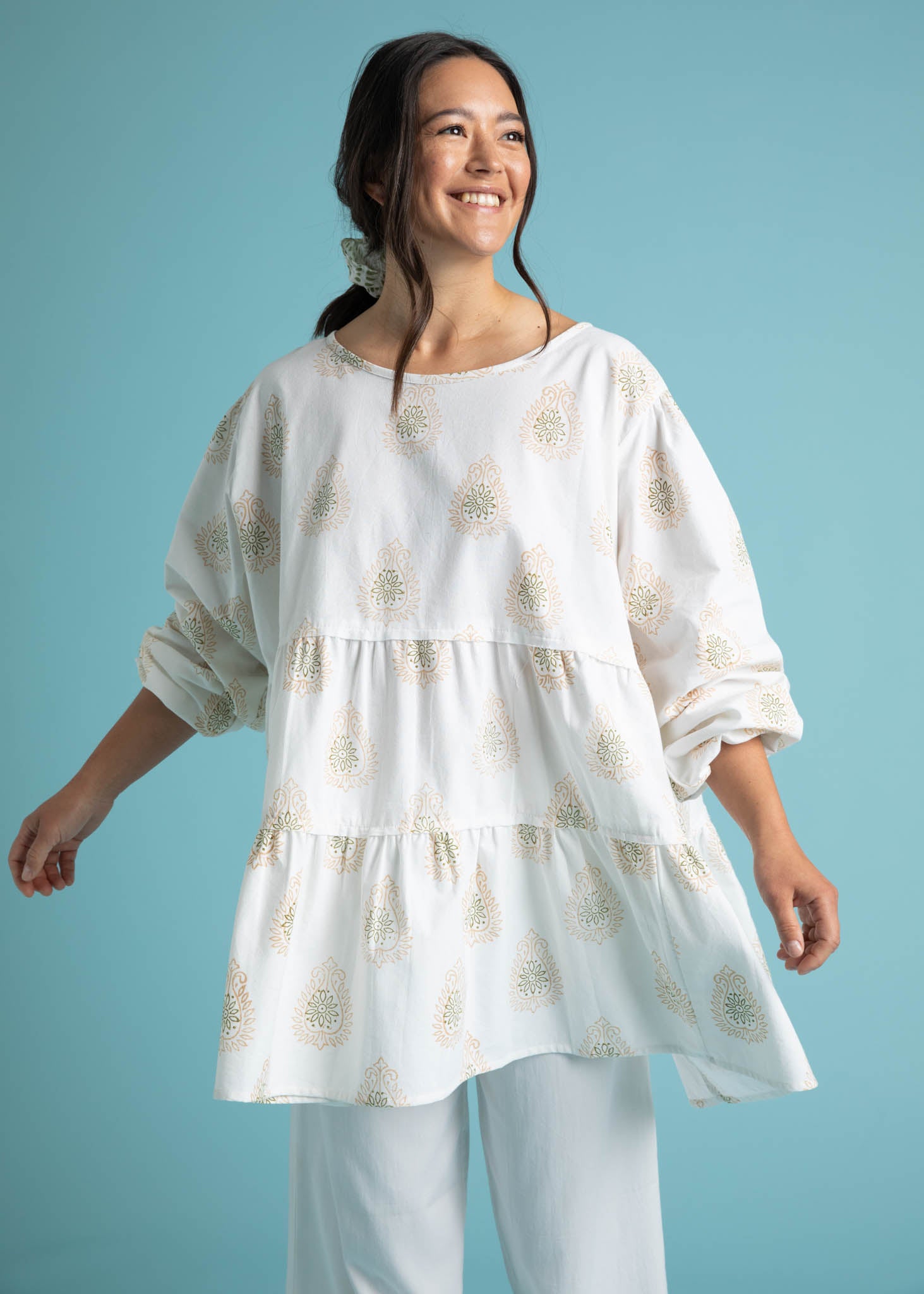 Meadow Tiered Tunic in Baked Clay featuring a flowy tiered design, long sleeves, and a keyhole back closure, made from organic cotton.