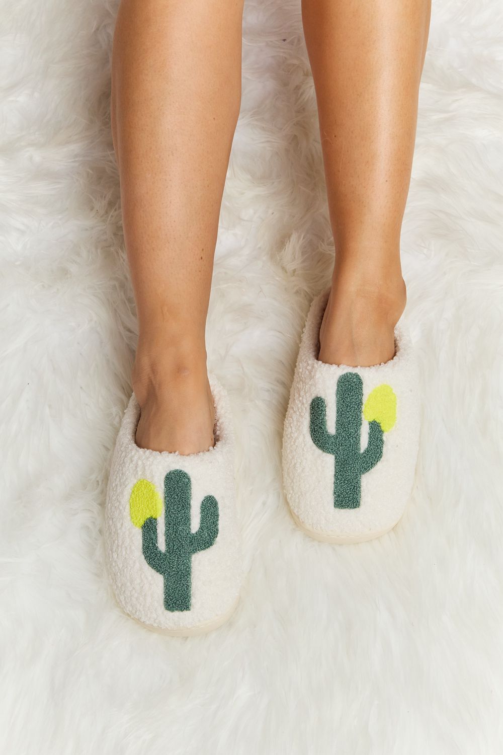 Melody Cactus Plush Slide Slippers featuring a cute cactus pattern, ultra-soft plush material, and a flexible rubber sole for comfort and support.