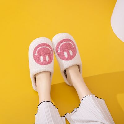 Cozy Melody Smiley Face Slippers with plush faux fur and rubber sole, featuring a cheerful smiley face design.