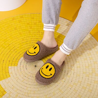 Cozy Melody Smiley Face Slippers with plush faux fur and rubber sole, featuring a cheerful smiley face design.